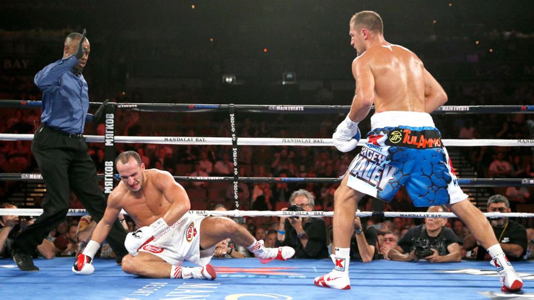 Sergey Kovalev knocks down Nadjib Mohammedi to win their light heavyweight title boxing bout Saturday, July 25, 2015, in Las Vegas. (AP Photo/John Locher)