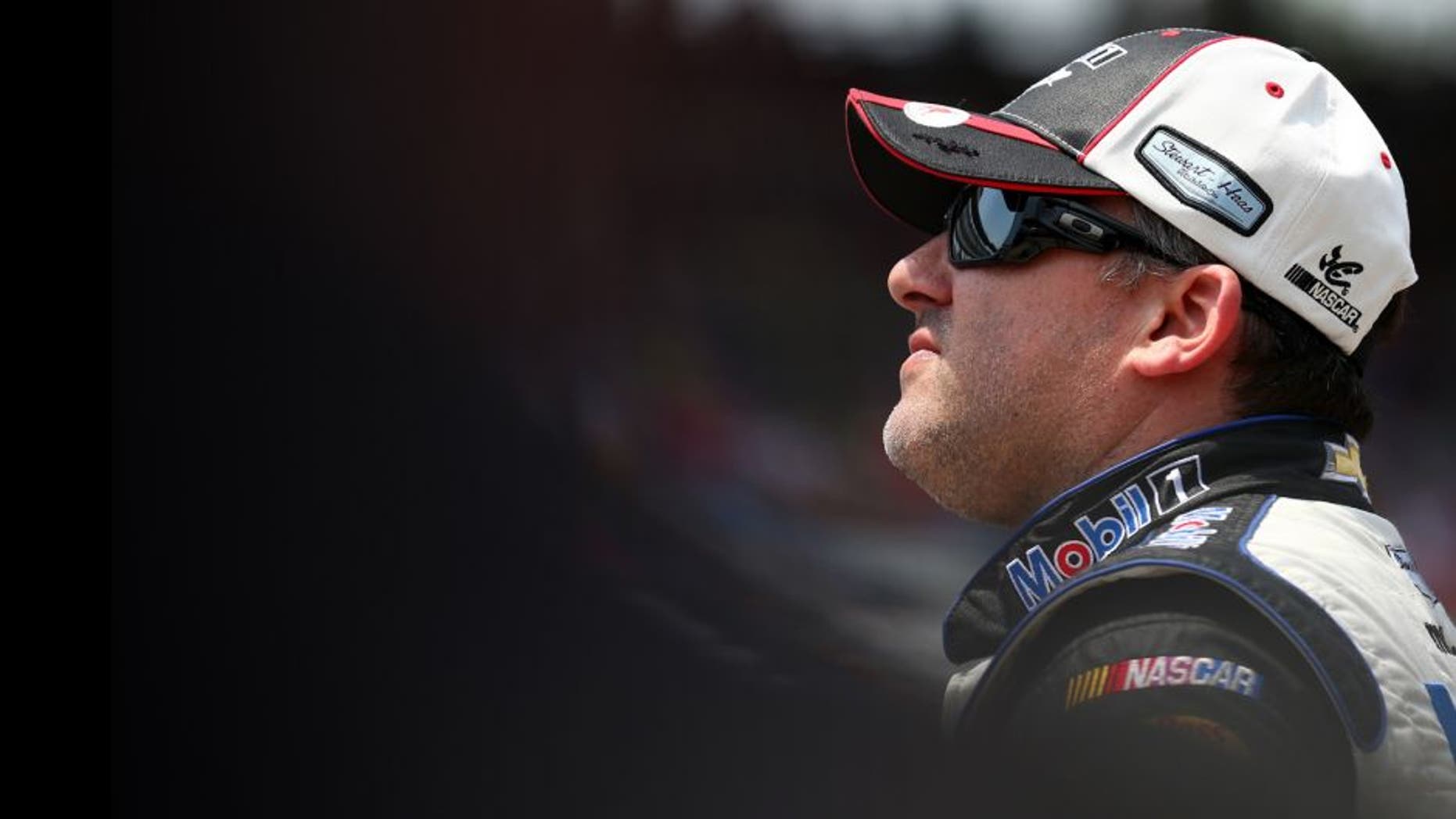 INDIANAPOLIS, IN - JULY 25: Tony Stewart, driver of the #14 Mobil 1/Bass Pro Shops Chevrolet, looks on during qualifying for the NASCAR Sprint Cup Series Crown Royal Presents the Jeff Kyle 400 at the Brickyard at Indianapolis Motor Speedway on July 25, 2015 in Indianapolis, Indiana. (Photo by Sarah Crabill/NASCAR via Getty Images)