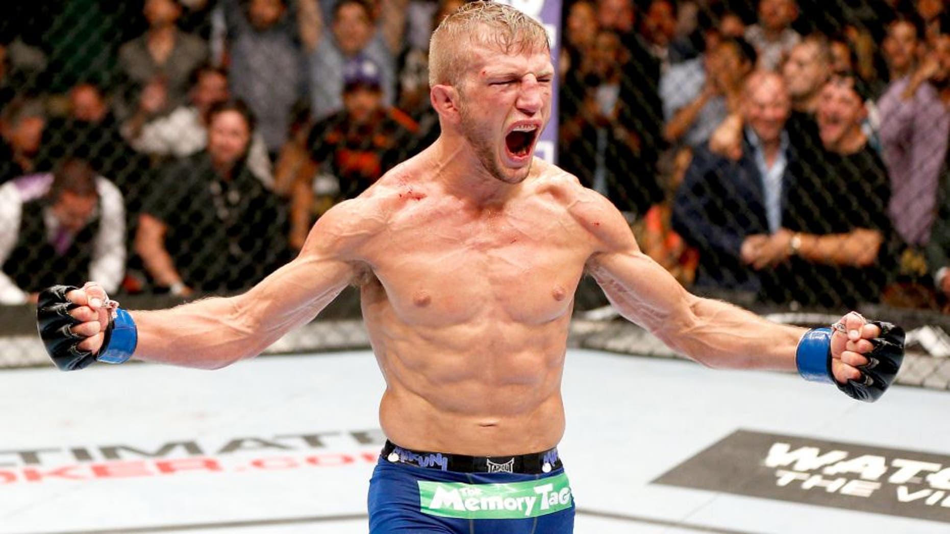 LAS VEGAS, NV - MAY 24: T.J. Dillashaw reacts to his victory over Renan Barao in their bantamweight championship bout during the UFC 173 event at the MGM Grand Garden Arena on May 24, 2014 in Las Vegas, Nevada. (Photo by Josh Hedges/Zuffa LLC/Zuffa LLC via Getty Images)