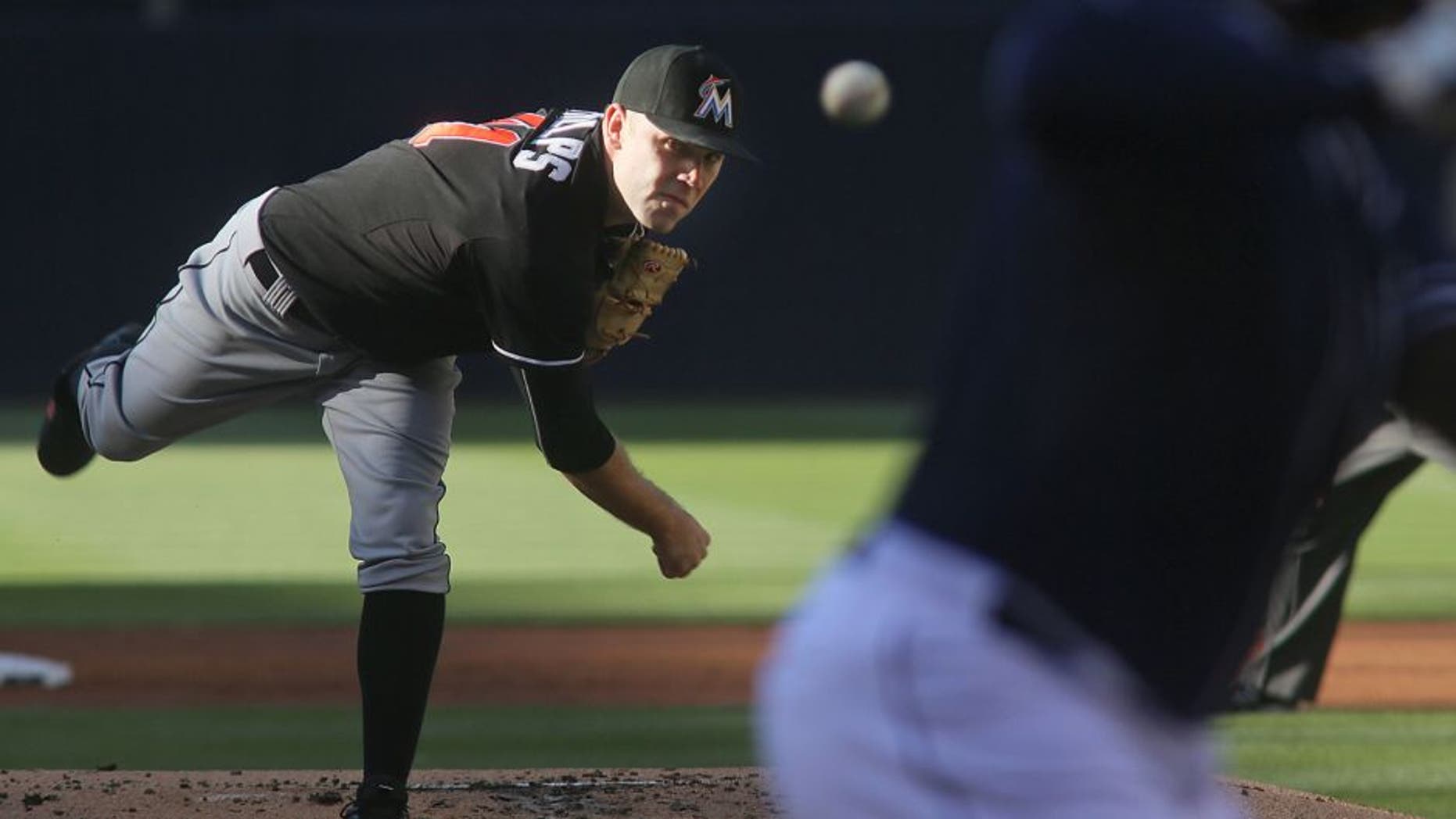 Miami Marlins starting pitcher David Phelps throws to a San Diego Padres batter during the first inning of a baseball game Saturday, July 25, 2015, in San Diego. (AP Photo/Sandy Huffaker)