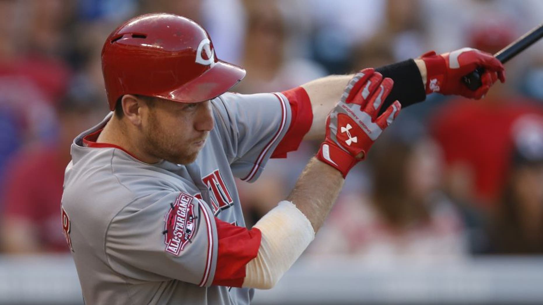 Cincinnati Reds' Todd Frazier follows the flight of his three-run home run off Colorado Rockies starting pitcher Chris Rusin in the third inning of a baseball game Saturday, July 25, 2015, in Denver.