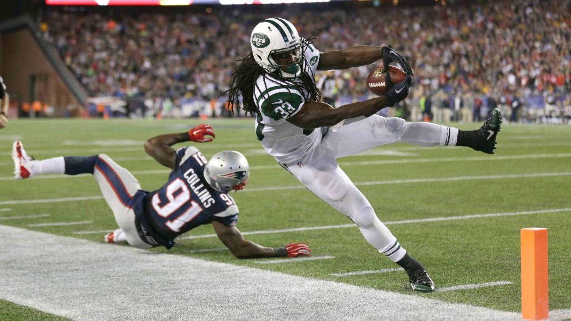 New York Jets running back Chris Ivory (33) goes out of bounds just short of the goal line next to New England Patriots outside linebacker Jamie Collins (91) in the second half of an NFL football game Thursday, Oct. 16, 2014, in Foxborough, Mass. (AP Photo/Charles Krupa)