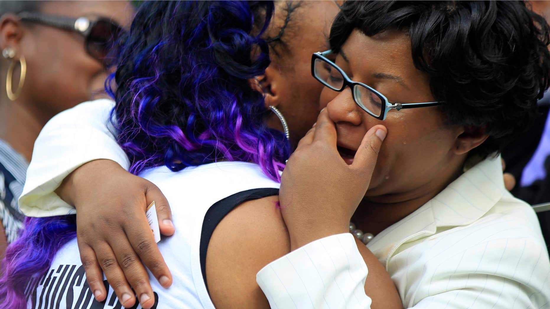 July 25, 2015: A mourner hugs Sandra Bland's sister Sharon Cooper at the Mt. Glenwood Memorial Gardens West cemetery in Willow Springs, Ill.