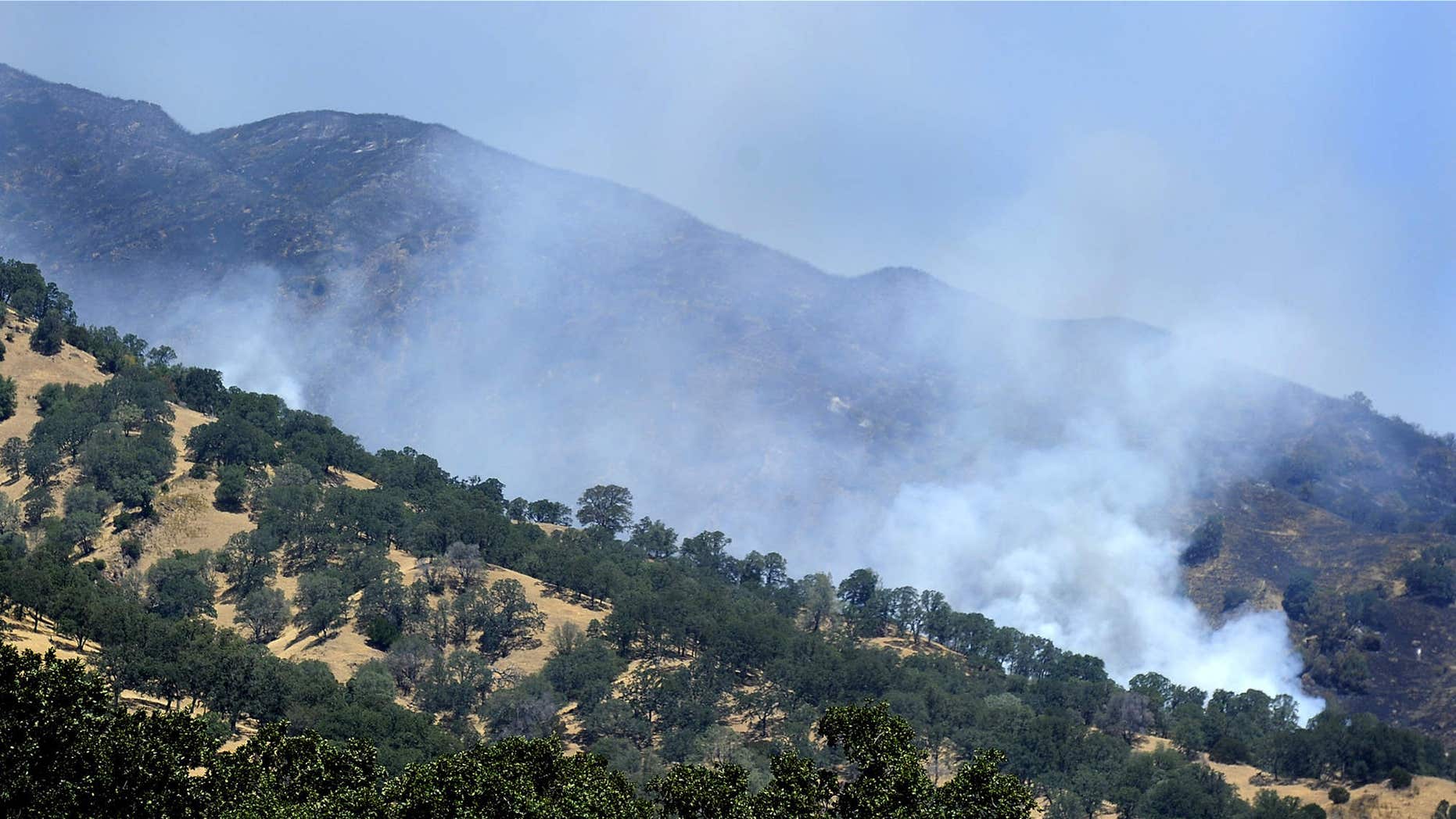 July 24, 2015: Smoke billows along a ridgeline at the southern most portion of the Wragg Fire near Winters, Calif.