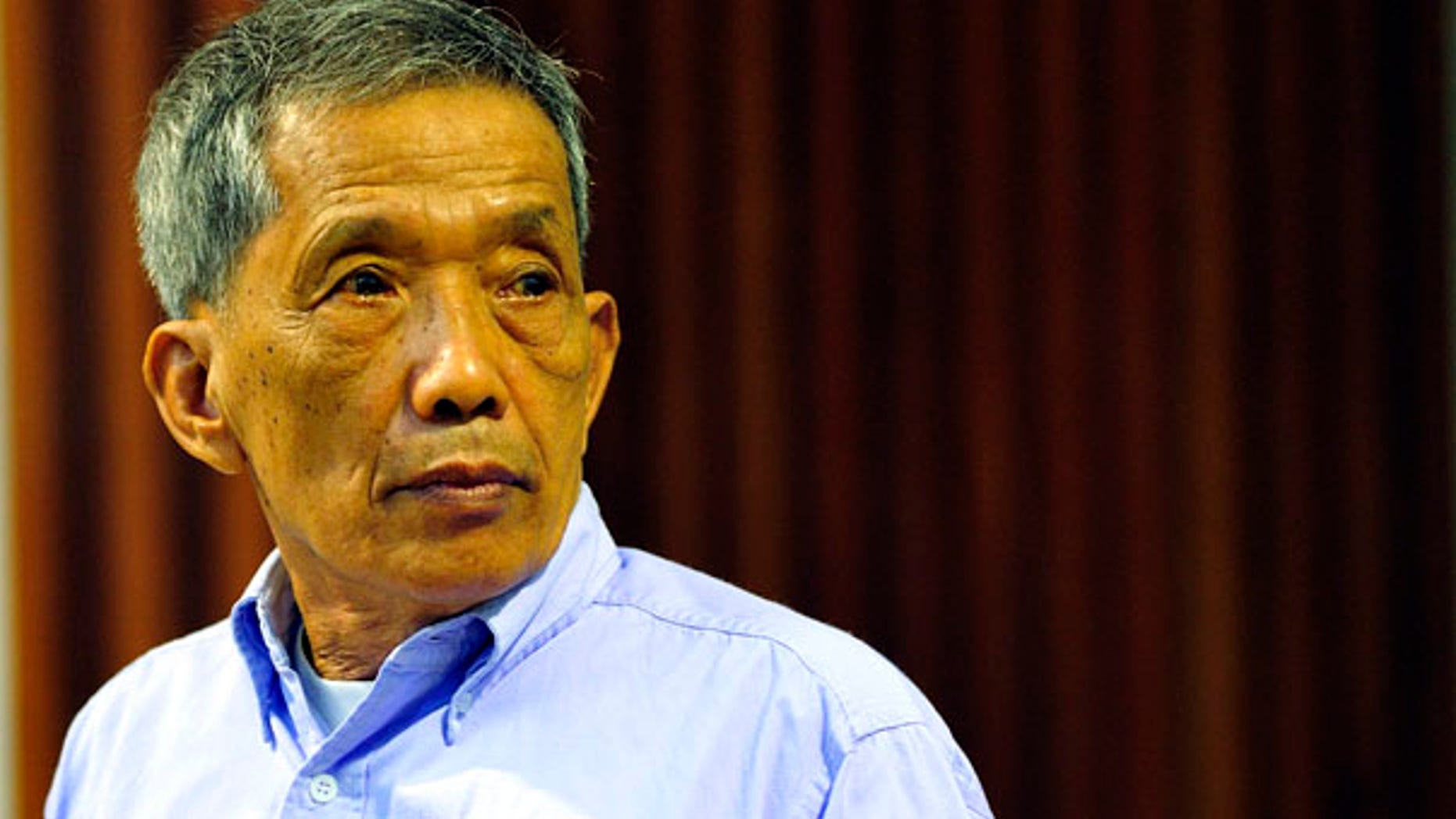 July 26: Khmer Rouge jailer Kaing Guek Eav, who ran a top secret detention center for the worst "enemies" of the state, looks on during his sentencing at the U.N.-backed war crimes tribunal in Phnom Penh, Cambodia.