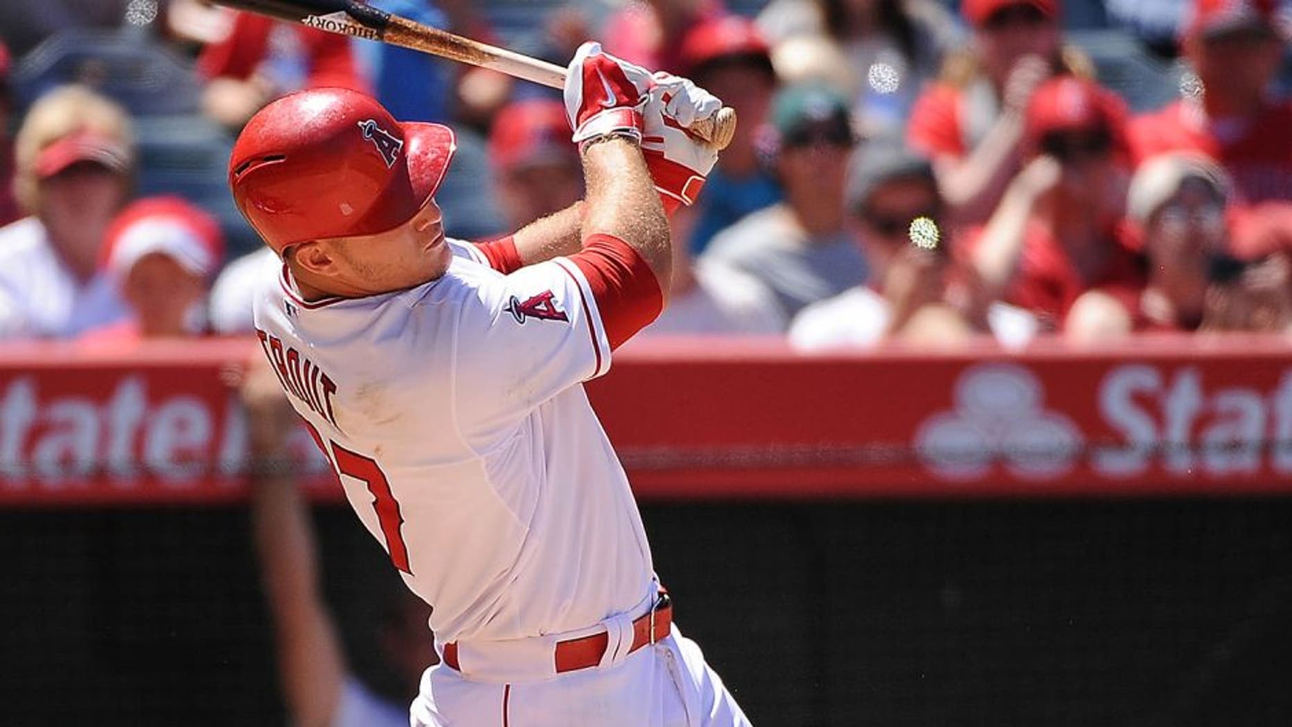 ANAHEIM, CA - JULY 26: Mike Trout #27 of the Los Angeles Angels of Anaheim follows through on a grand slam home run in the sixth inning during a game against the Texas Rangers at Angel Stadium of Anaheim on July 26, 2015 in Anaheim, California. (Photo by Jonathan Moore/Getty Images)