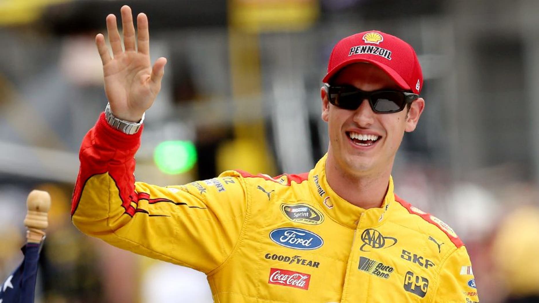 INDIANAPOLIS, IN - JULY 26: Joey Logano, driver of the #22 Shell Pennzoil Ford, waves prior to the NASCAR Sprint Cup Series Crown Royal Presents the Jeff Kyle 400 at the Brickyard at Indianapolis Motor Speedway on July 26, 2015 in Indianapolis, Indiana. (Photo by Andy Lyons/Getty Images)