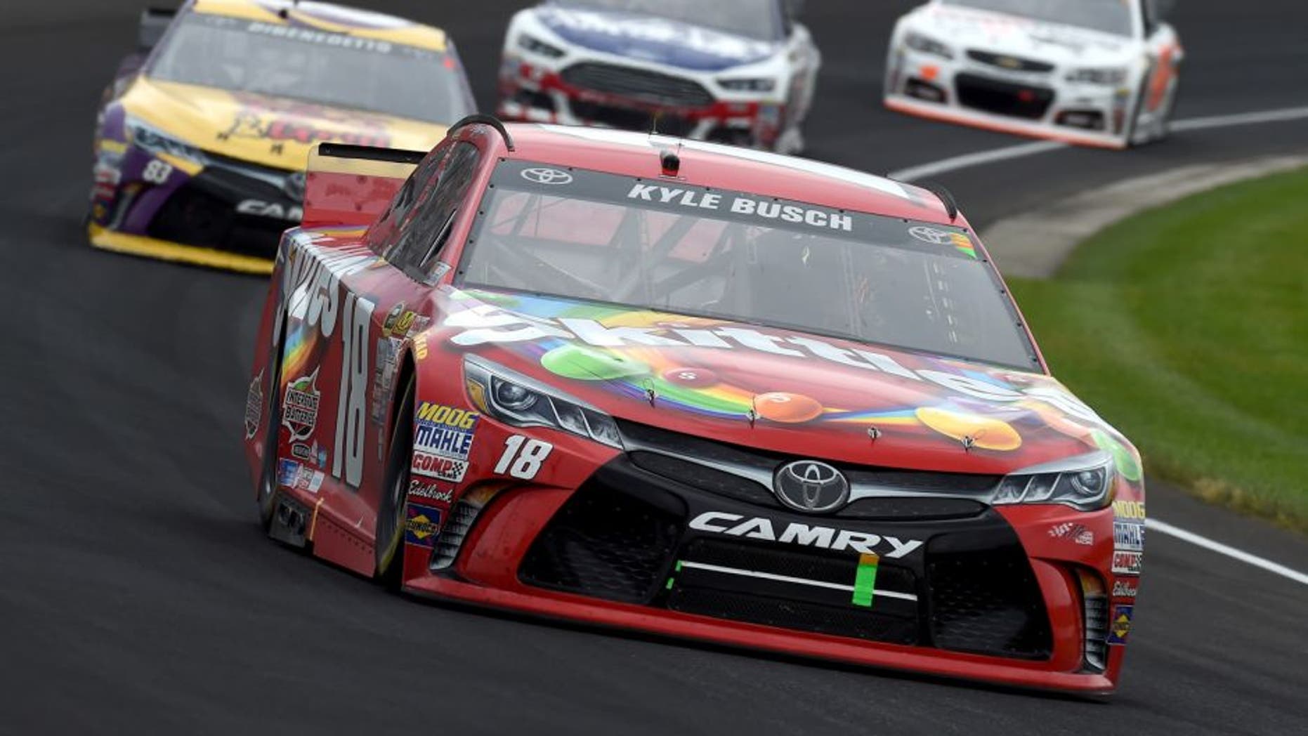 INDIANAPOLIS, IN - JULY 26: Kyle Busch, driver of the #18 Skittles Toyota, leads a pack of cars during the NASCAR Sprint Cup Series Crown Royal Presents the Jeff Kyle 400 at the Brickyard at Indianapolis Motor Speedway on July 26, 2015 in Indianapolis, Indiana. (Photo by Rainier Ehrhardt/NASCAR via Getty Images)