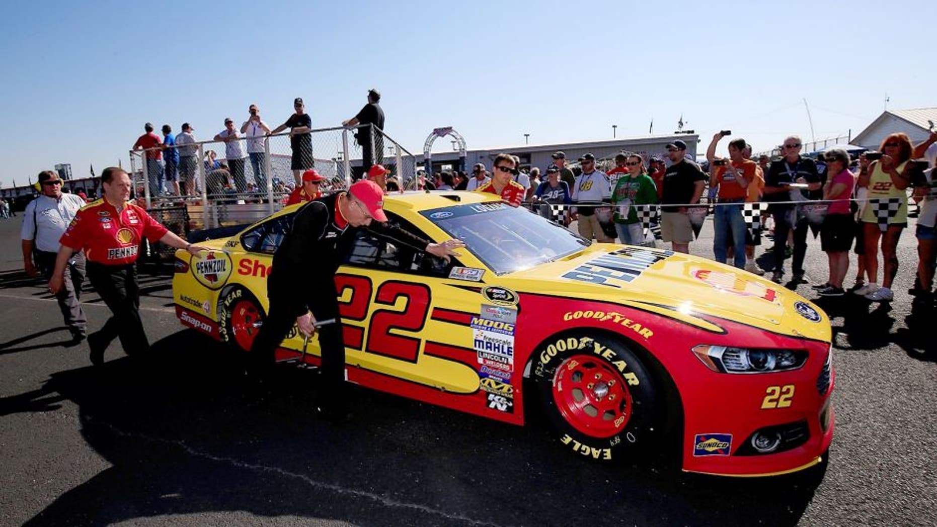 TALLADEGA, AL - MAY 03: Crew members push the car of Joey Logano, driver of the #22 Shell Pennzoil Ford, through the garage area prior to the NASCAR Sprint Cup Series GEICO 500 at Talladega Superspeedway on May 3, 2015 in Talladega, Alabama. (Photo by Chris Trotman/NASCAR via Getty Images)