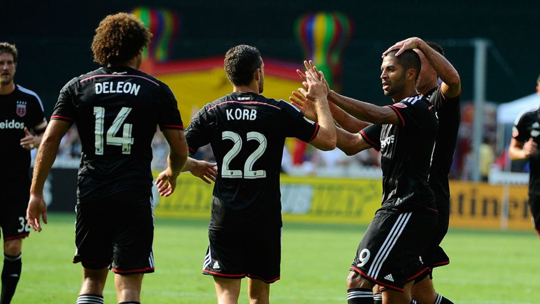 Jul 26, 2015; Washington, DC, USA; D.C. United forward Alvaro Saborio (9) is congratulated by teammates after scoring a goal against the Philadelphia Union during the first half at Robert F. Kennedy Memorial. Mandatory Credit: Brad Mills-USA TODAY Sports