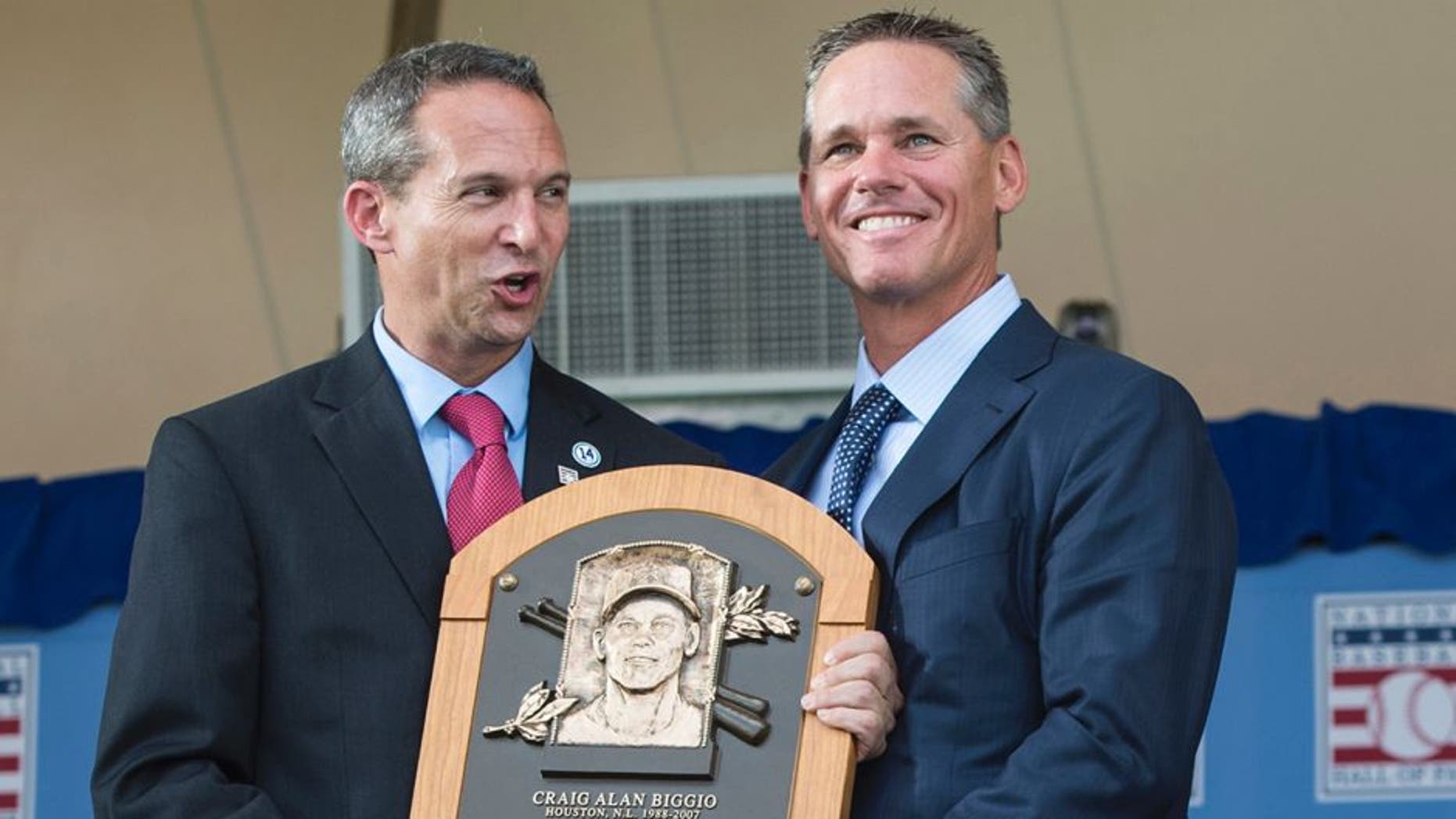 Jul 26, 2015; Cooperstown, NY, USA; Hall of Fame President Jeff Idelson (L) presents Hall of Fame Inductee Craig Biggio (R) with his Hall of Fame Plague during the Hall of Fame Induction Ceremonies at Clark Sports Center. Mandatory Credit: Gregory J. Fisher-USA TODAY Sports