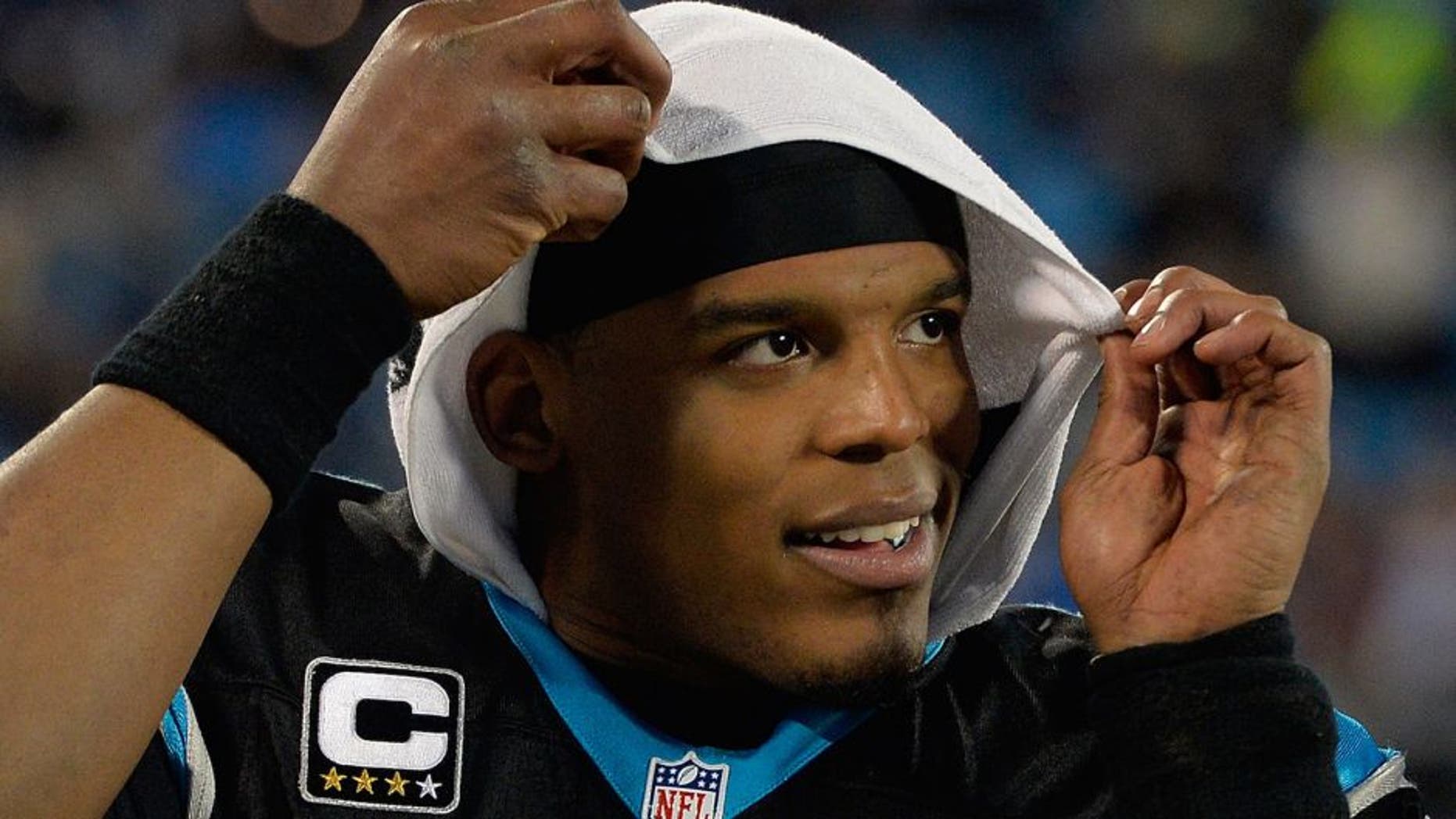 CHARLOTTE, NC - JANUARY 03: Cam Newton #1 of the Carolina Panthers watches from the sideline during the final minute of their game against the Tampa Bay Buccaneers at Bank of America Stadium on January 3, 2016 in Charlotte, North Carolina. The Panthers won 38-10 to clinch home field advantage for the playoffs. (Photo by Grant Halverson/Getty Images)