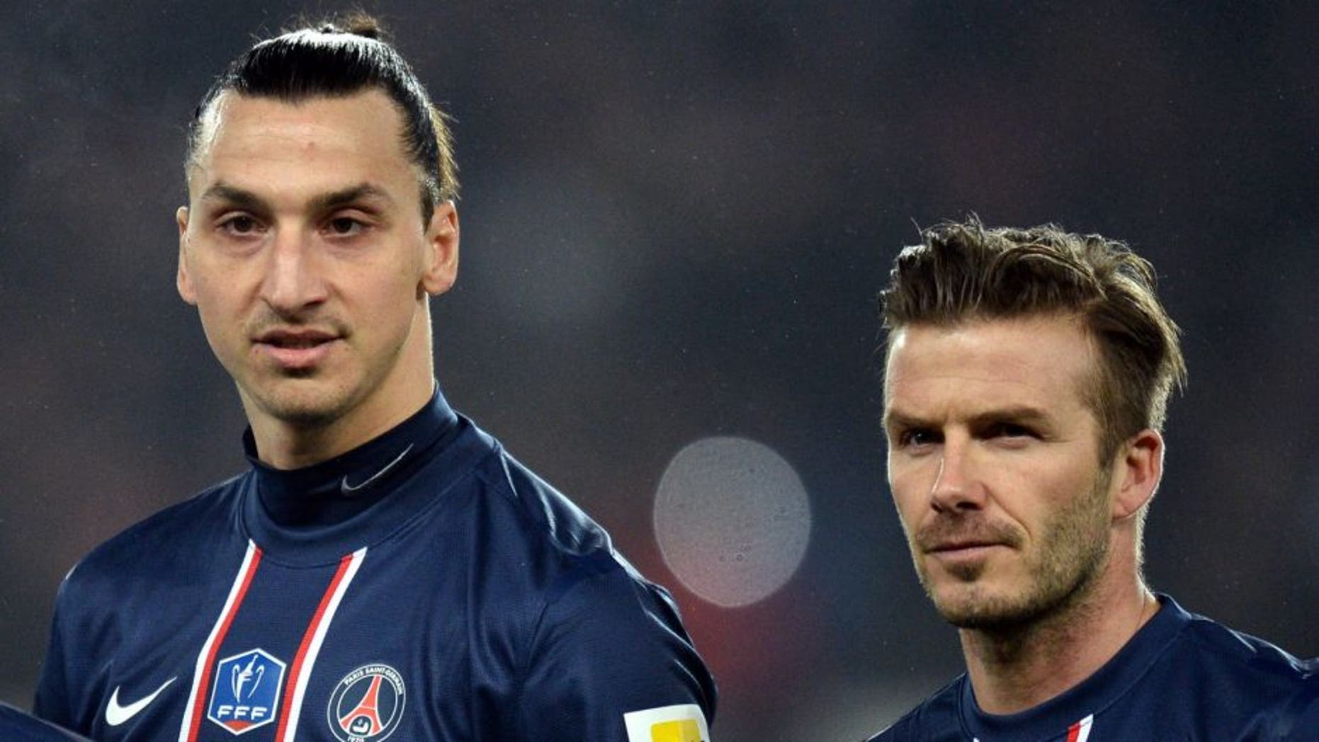 Paris Saint-Germain's Swedish forward Zlatan Ibrahimovic (L) and Paris Saint-Germain's English midfielder David Beckham (R) wait the start of the French Cup football match Paris Saint-Germain vs Marseille February 27, 2013 at the Parc des Princes stadium in Paris. AFP PHOTO/ FRANCK FIFE (Photo credit should read FRANCK FIFE/AFP/Getty Images)