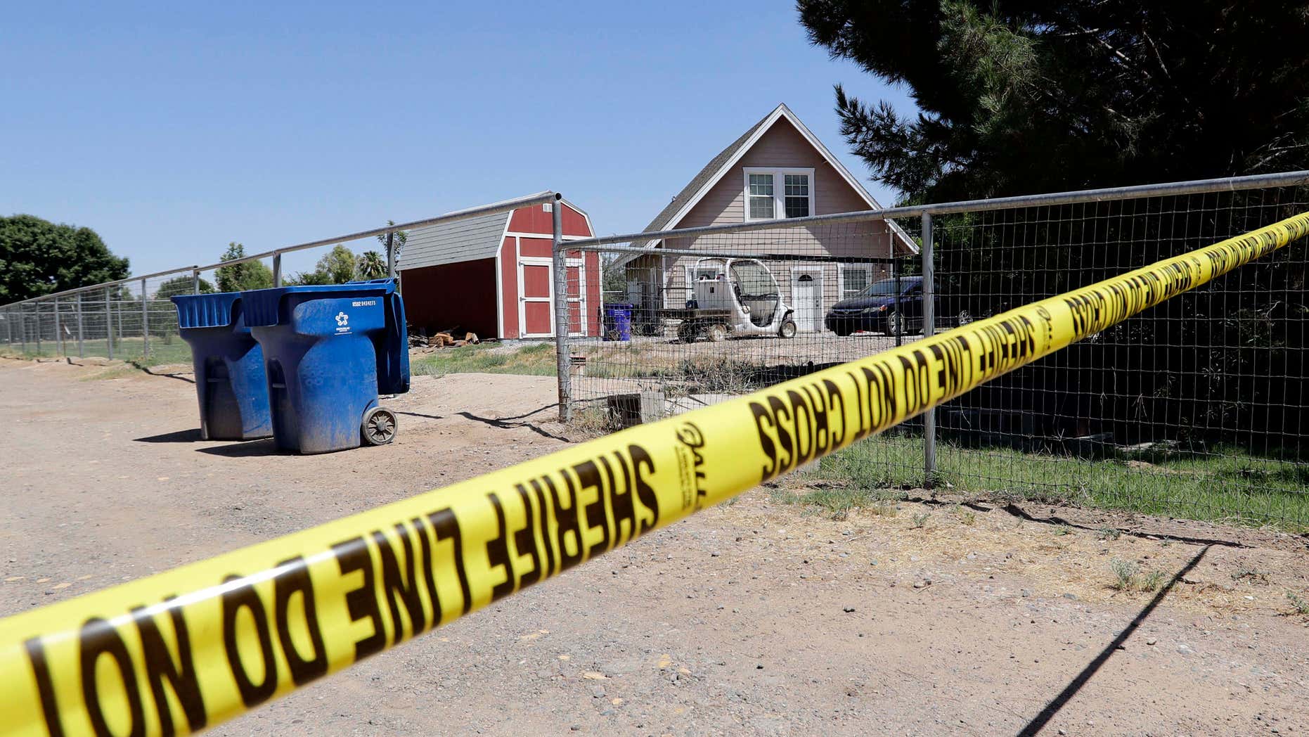 Crime scene tape blocks the entrance to a home where multiple bodies were found, Tuesday, July 26, 2016, in Gilbert, Ariz.