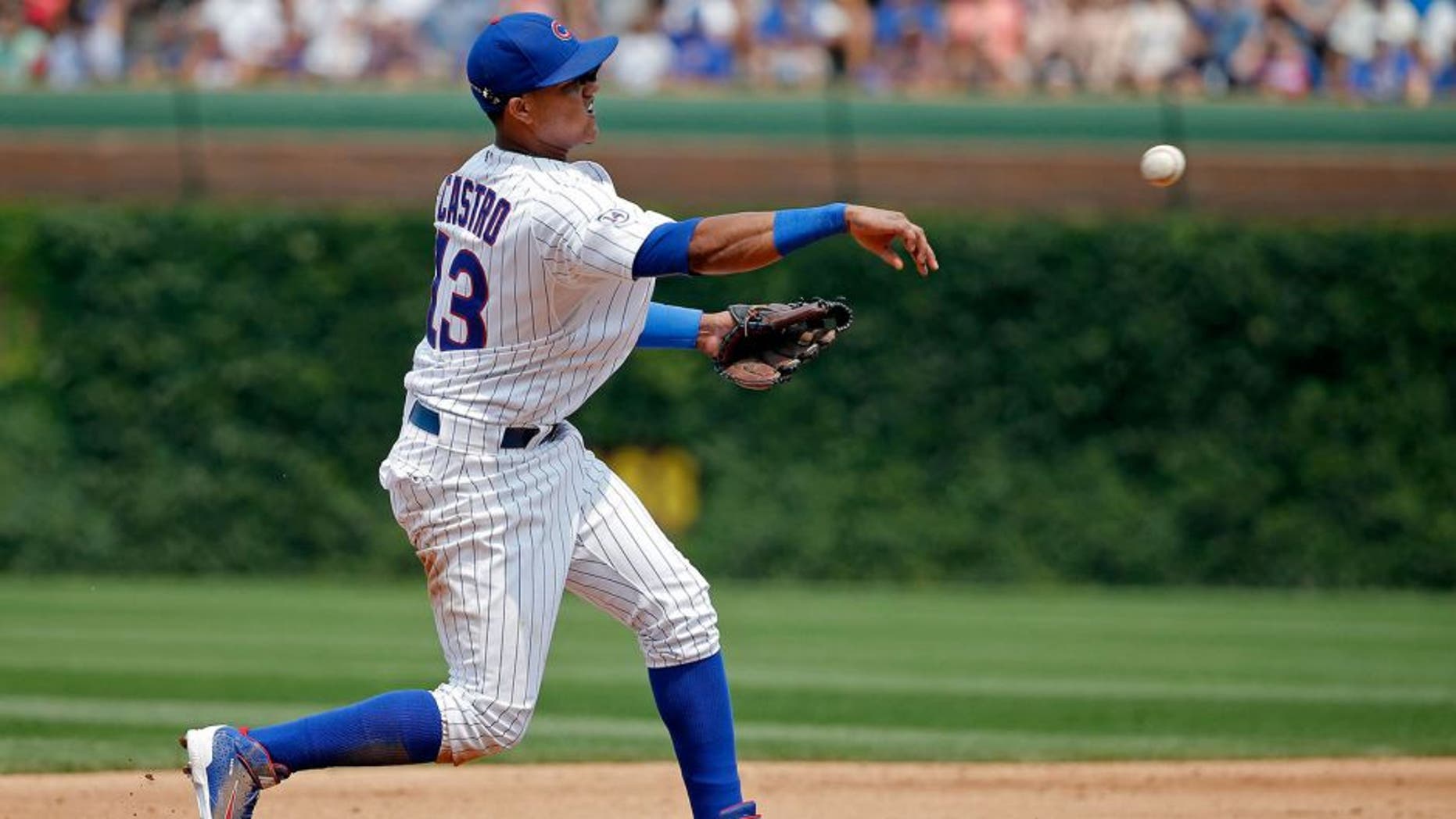 CHICAGO, IL - JULY 05: Starlin Castro #13 of the Chicago Cubs throws to first base for the out against the Miami Marlins during the fifth inning at Wrigley Field on July 5, 2015 in Chicago, Illinois. (Photo by Jon Durr/Getty Images)