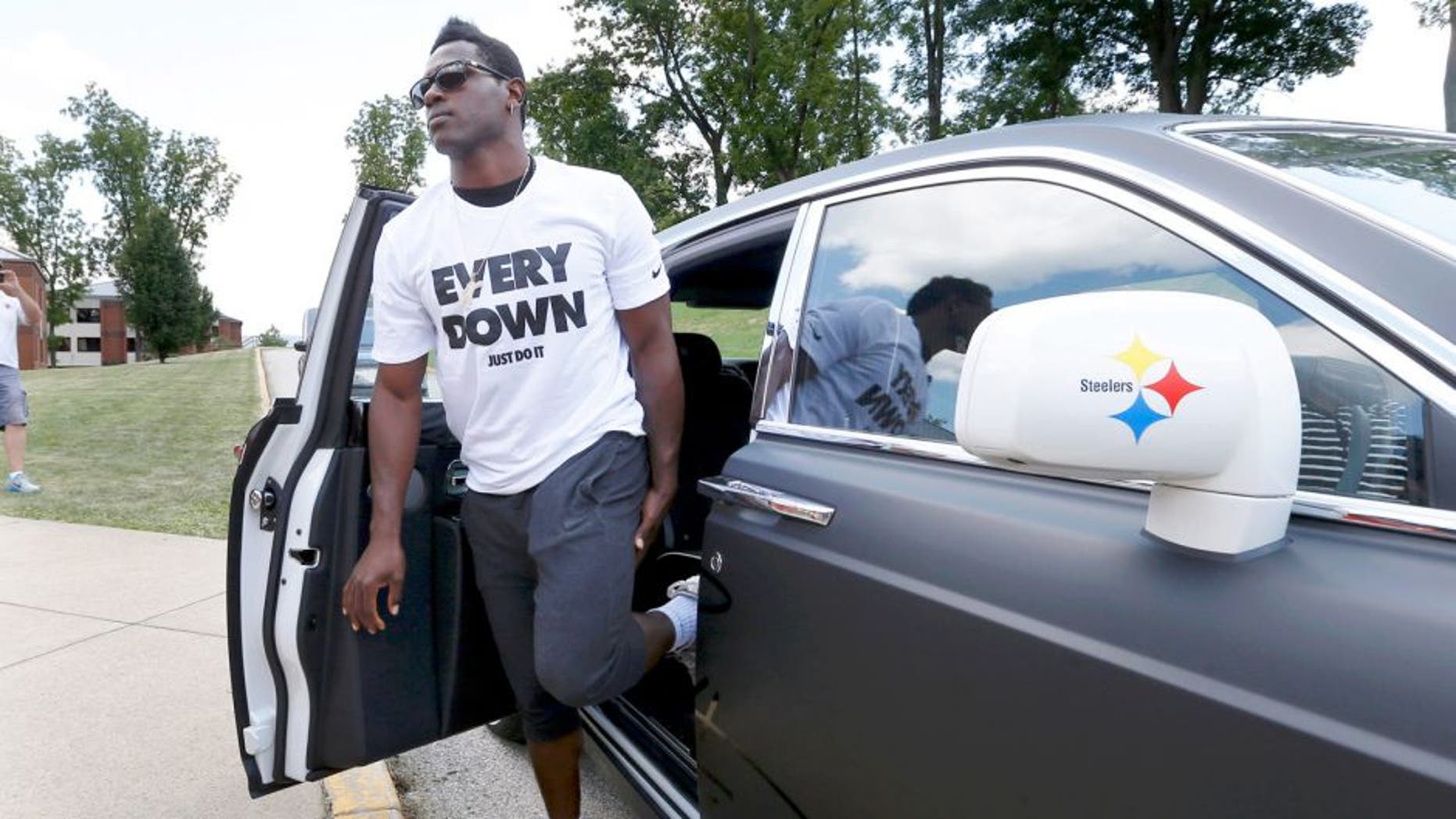 Pittsburgh Steelers wide receiver Antonio Brown gets out of his custom Steelers-themed Rolls Royce as he arrives for NFL football training camp at the team's training facility in Latrobe, Pa., Saturday, July 25, 2015. (AP Photo/Keith Srakocic)