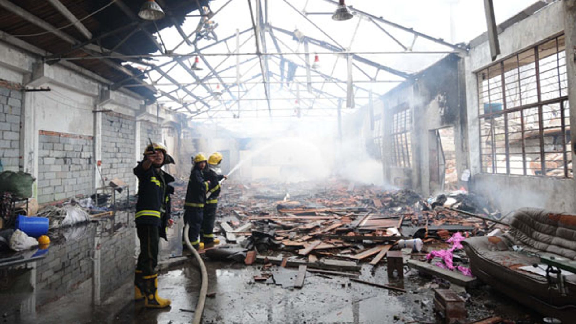 July 28: Firemen put out a fire in Nanjing after a powerful blast caused by a suspected gas leak rocked a plastics factory in eastern China, killing at least 12 people and seriously injuring 28.