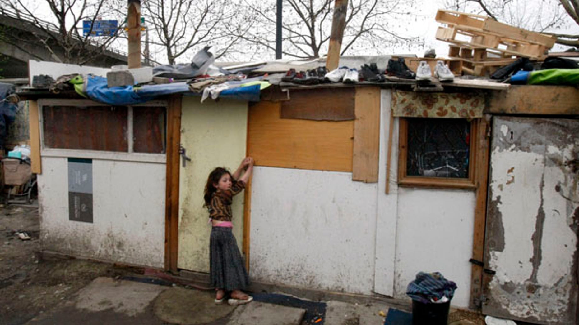 March 26: A young gypsy girl is seen in a makeshift camp in Saint Denis, a northern suburb of Paris.