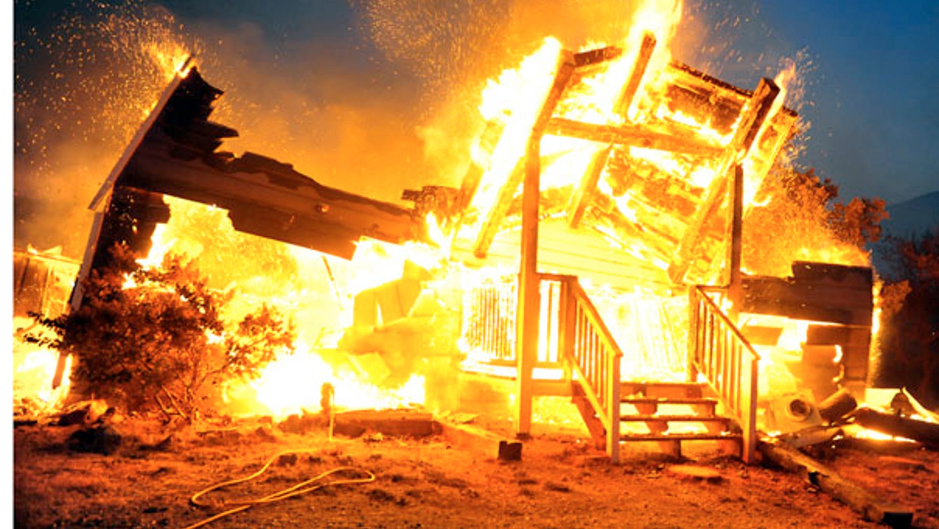 July 27: A house in Tehachapi, Calif., burns as two wildfires erupted and spread quickly in Southern California, destroying dozens of homes and forcing evacuations in remote areas of the state's Kern County.