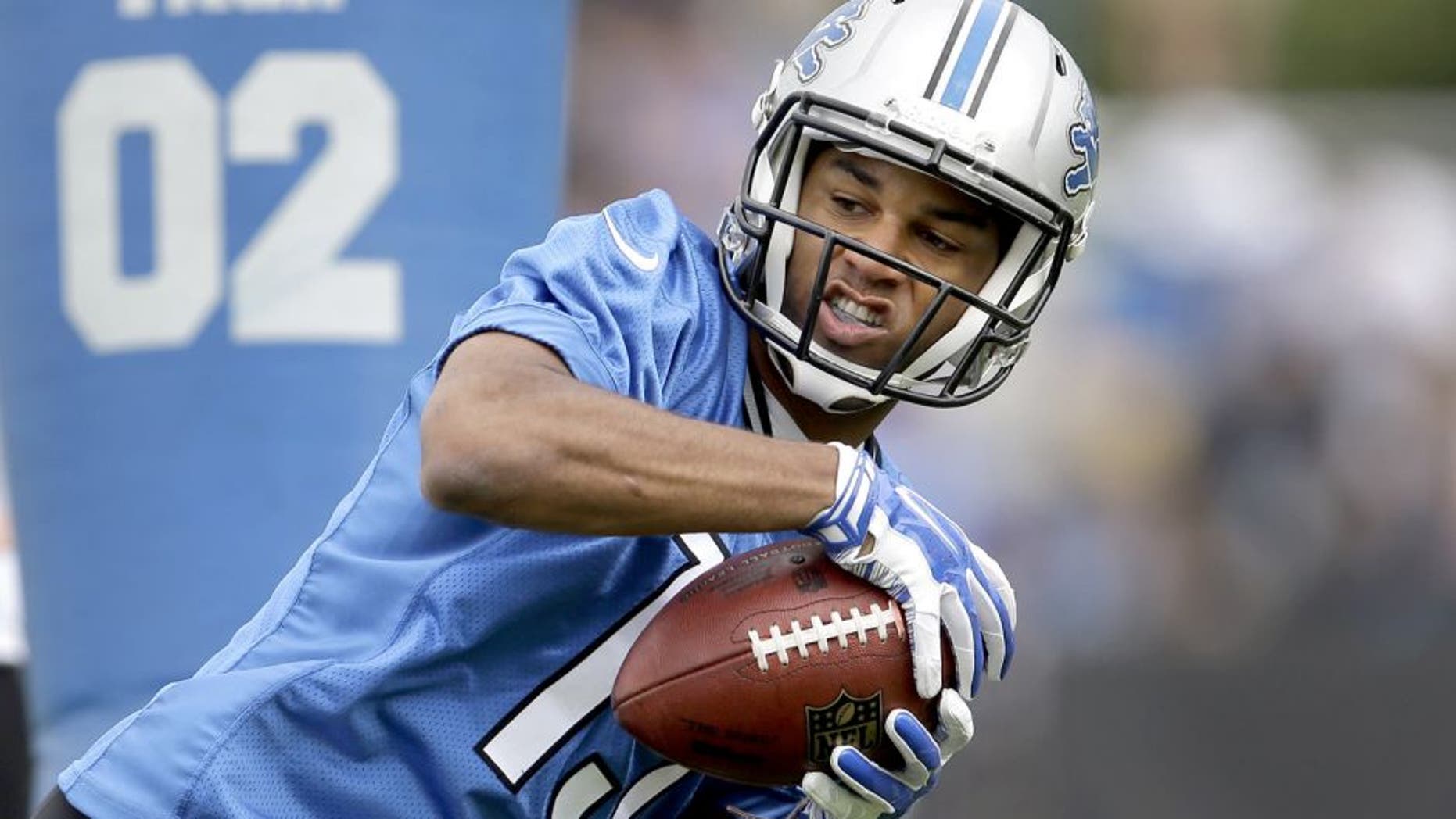 Detroit Lions wide receiver Golden Tate catches a pass during NFL football training camp in Allen Park, Mich., Monday, July 28, 2014. (AP Photo/Paul Sancya)