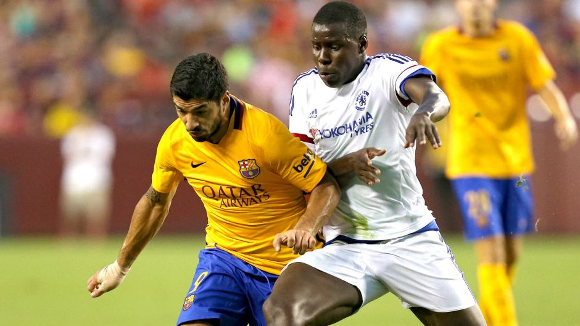 LANDOVER, MD - JULY 28: Luis Suarez #9 of Barcelona battles with Kurt Zouma #5 of Chelsea in the first half during the International Champions Cup North America at FedExField on July 28, 2015 in Landover, Maryland. (Photo by Patrick Smith/Getty Images)
