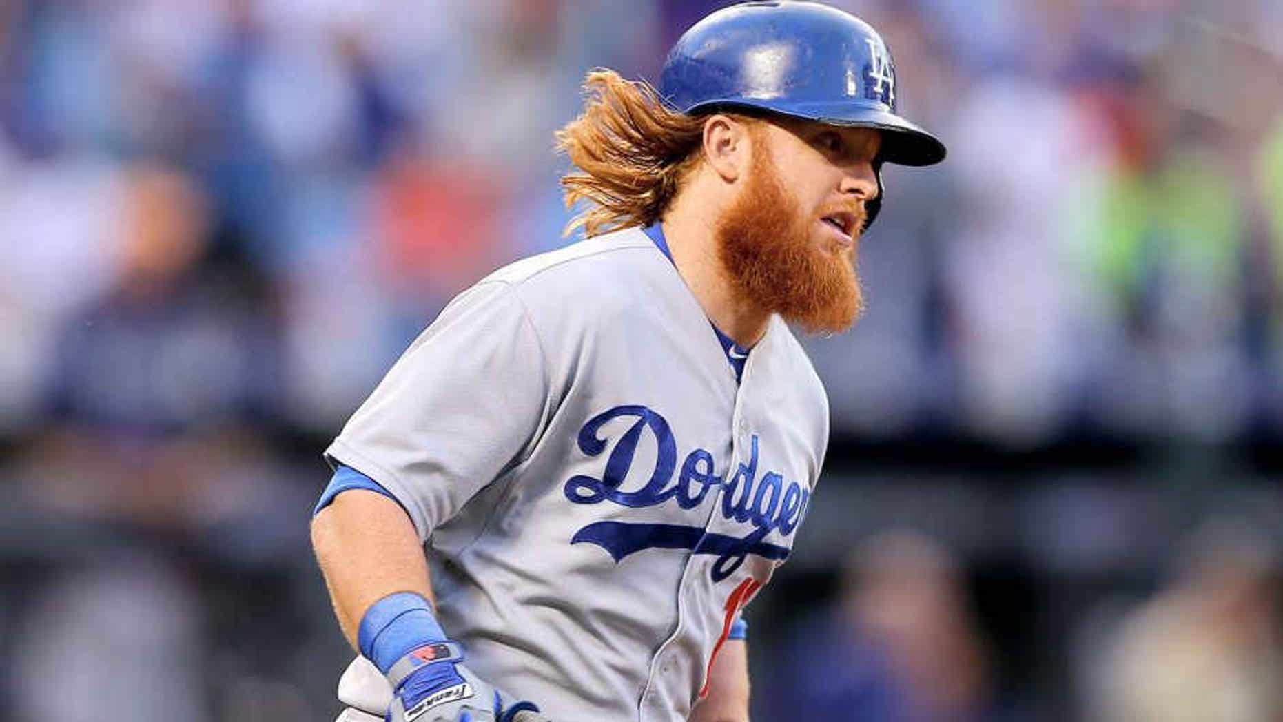 NEW YORK, NY - JULY 24: Justin Turner #10 of the Los Angeles Dodgers rounds first base after he hit a solo home run in the third inning against the New York Mets on July 24, 2015 at Citi Field in the Flushing neighborhood of the Queens borough of New York City. (Photo by Elsa/Getty Images)