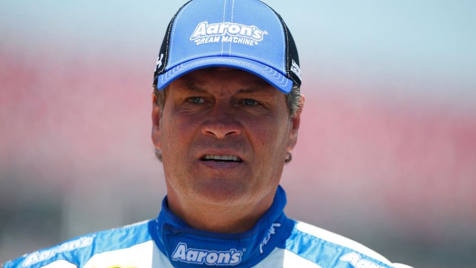 TALLADEGA, AL - MAY 02: Michael Waltrip, driver of the #55 Aaron's Dream Machine Toyota, stands on the grid during qualifying for the NASCAR Sprint Cup Series GEICO 500 at Talladega Superspeedway on May 2, 2015 in Talladega, Alabama. (Photo by Matt Sullivan/Getty Images)