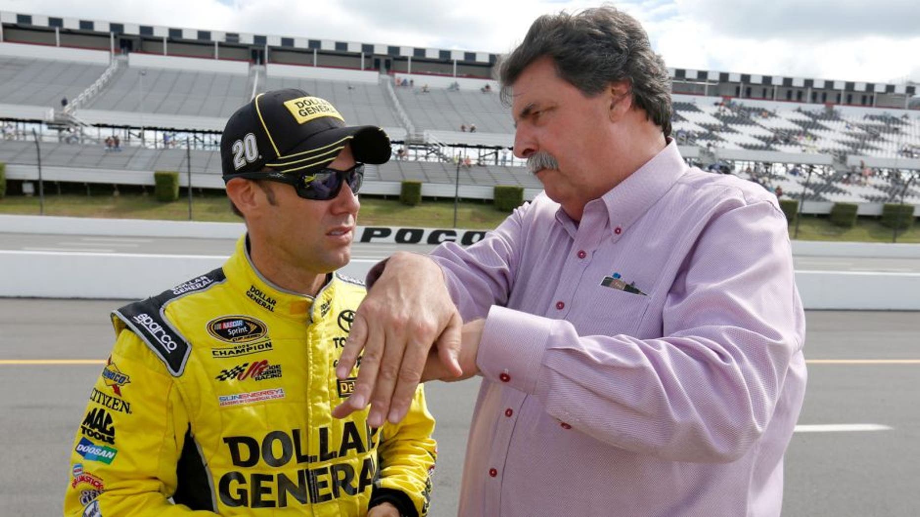 LONG POND, PA - JUNE 05: Matt Kenseth, driver of the #20 Dollar General Toyota, left, talks with Vice Chairman of NASCAR Mike Helton on the grid prior to qualifying for the NASCAR Sprint Cup Series Axalta "We Paint Winners" 400 at Pocono Raceway on June 5, 2015 in Long Pond, Pennsylvania. (Photo by Todd Warshaw/NASCAR via Getty Images)
