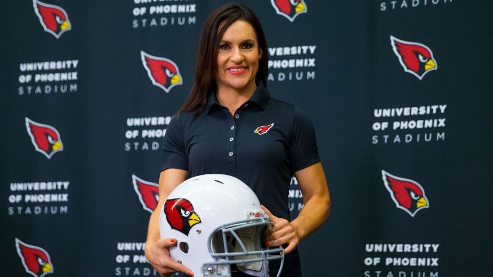 Jul 28, 2015; Tempe, AZ, USA; Arizona Cardinals inside linebackers intern and preseason coach Jen Welter holds a helmet as she poses for a photo during a press conference at the teams training facility. Mandatory Credit: Mark J. Rebilas-USA TODAY Sports
