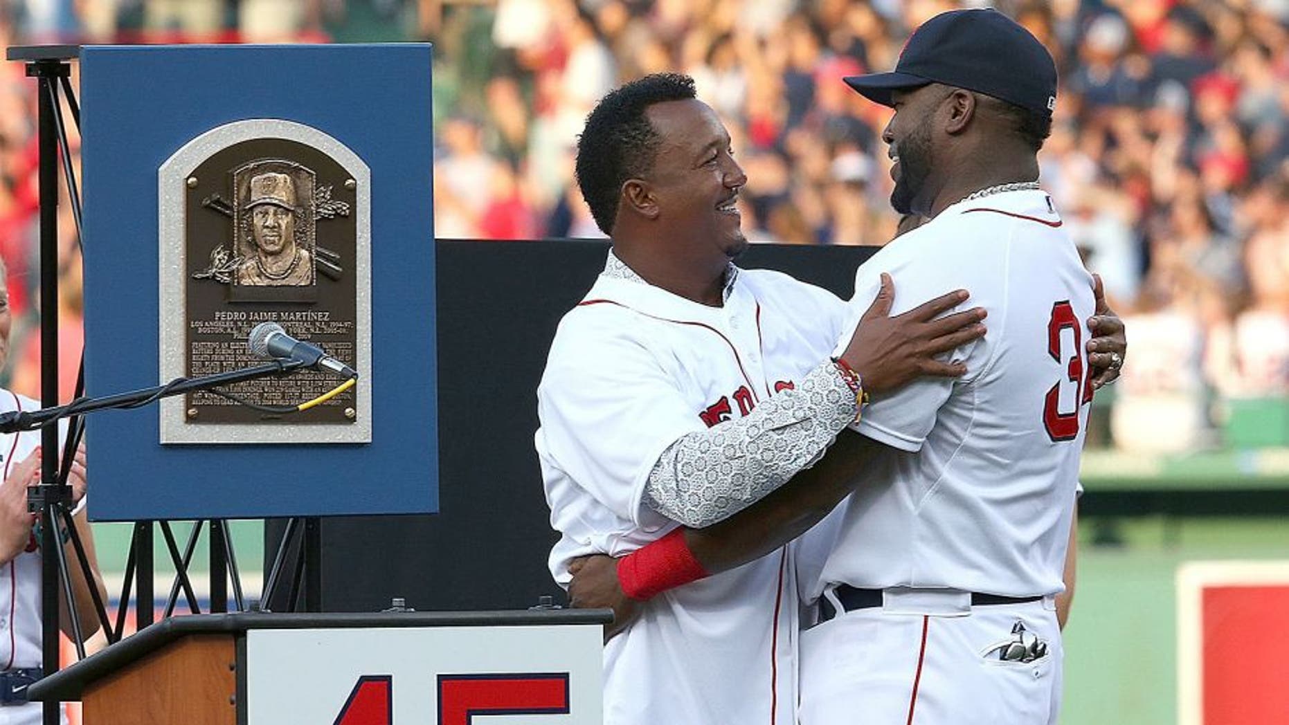 BOSTON, MA - JULY 28: David Ortiz #34 of the Boston Red Sox hugs Pedro Martinez, a former member of the Boston Red Sox, during a ceremony to retire Martinez's number 45 before a game with the Chicago White Sox at Fenway Park on July 28, 2015 in Boston, Massachusetts. (Photo by Jim Rogash/Getty Images)