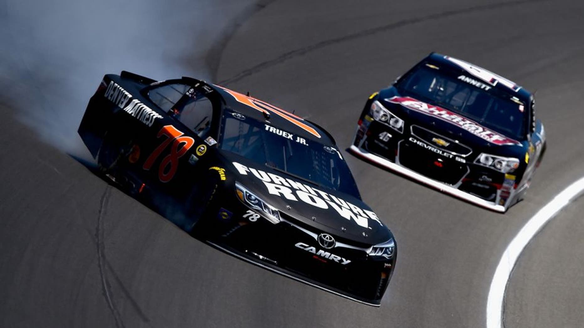 BROOKLYN, MI - JUNE 12: Martin Truex Jr, driver of the #78 Furniture Row Toyota, spins on the track in front of Michael Annett, driver of the #46 All State Peterbilt Chevrolet, during the NASCAR Sprint Cup Series FireKeepers Casino 400 at Michigan International Speedway on June 12, 2016 in Brooklyn, Michigan. (Photo by Josh Hedges/Getty Images )