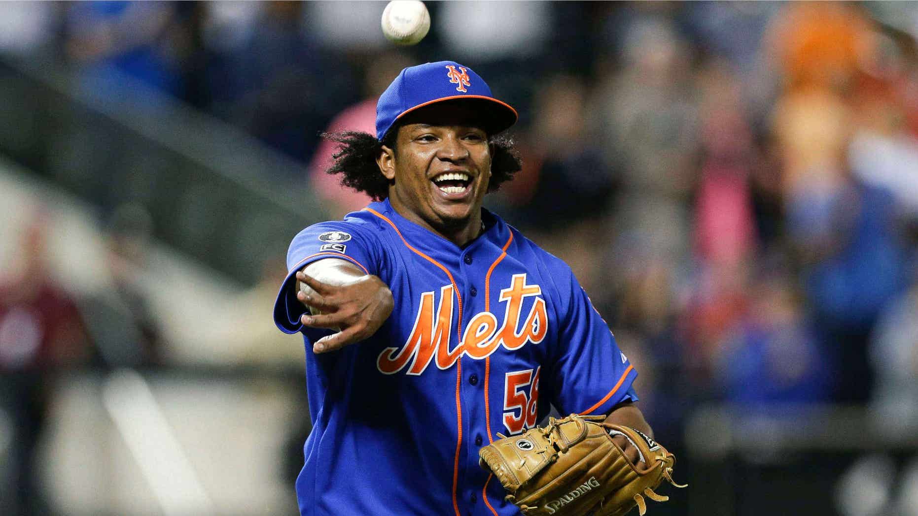Sept. 10, 2014: New York Mets relief pitcher Jenrry Mejia tosses the ball to throw out Colorado Rockies' Josh Rutledge at first base to end a baseball game, in New York.