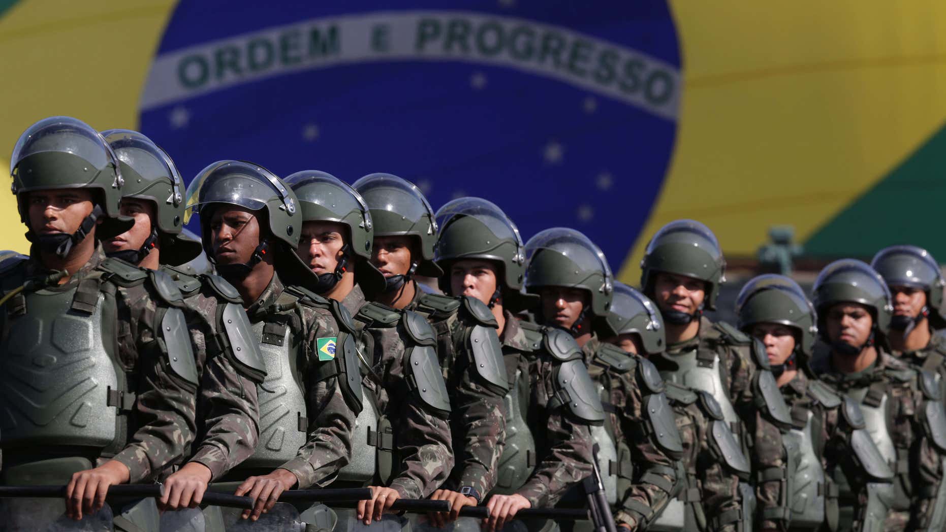 FILE - In this July 22, 2016 photo, Brazilian Army soldiers take part in military exercise during presentation of the security forces for the Rio 2016 Olympic Games, in front of the National Stadium, in Brasilia, Brazil.