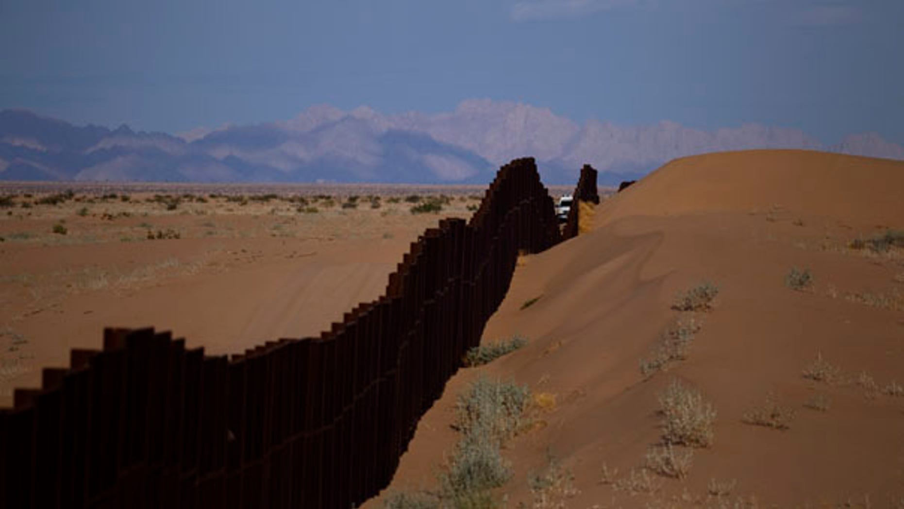 July 28: A US border patrol vehicle drives along the U.S.-Mexico border fence near Yuma, Arizona.