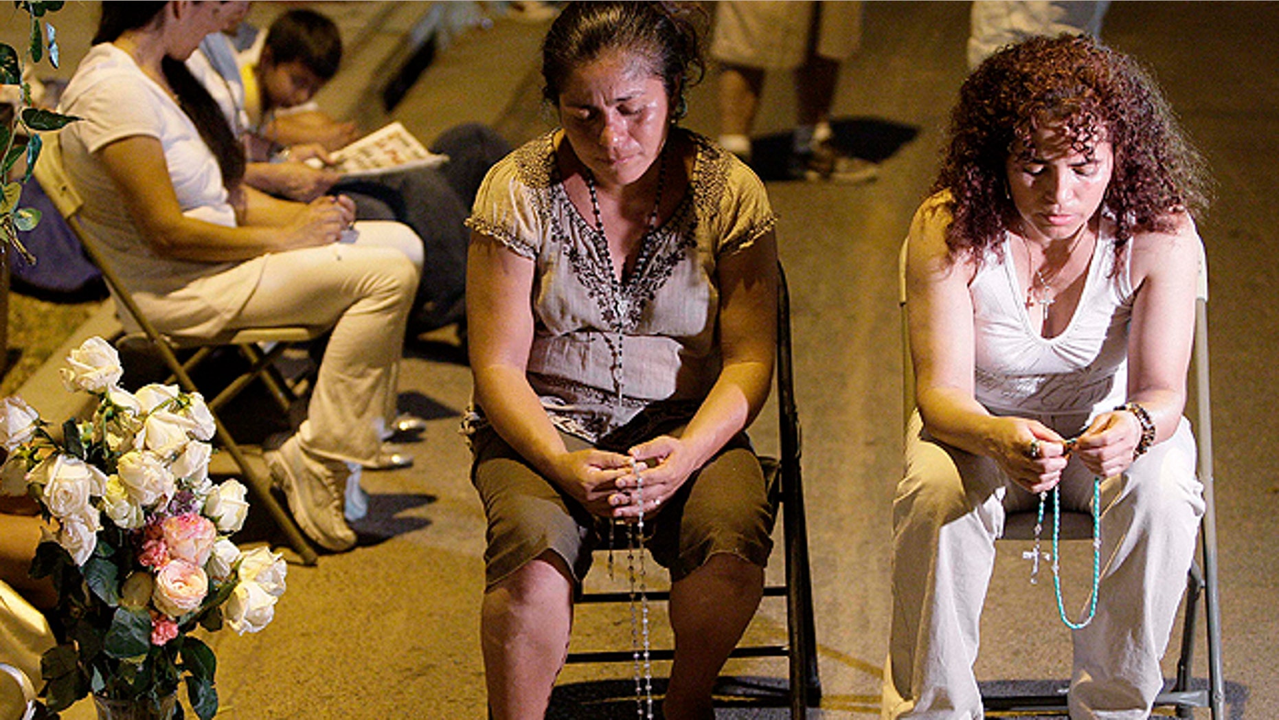 Women pray as they join dozens attending an overnight vigil at the Arizona Capitol late Wednesday in Phoenix, only hours after portions of Arizona's new immigration law, S.B. 1070, was blocked by a federal judge.