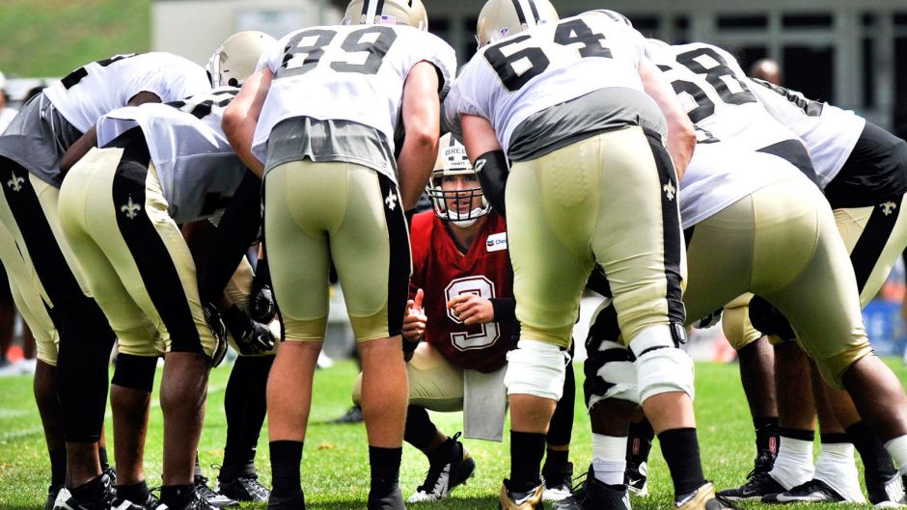 Jul 28, 2014; White Sulpher Springs, WV, USA; New Orleans Saints quarterback Drew Brees (9) huddles with the offense during training camp at The Greenbrier. Mandatory Credit: Michael Shroyer-USA TODAY Sports