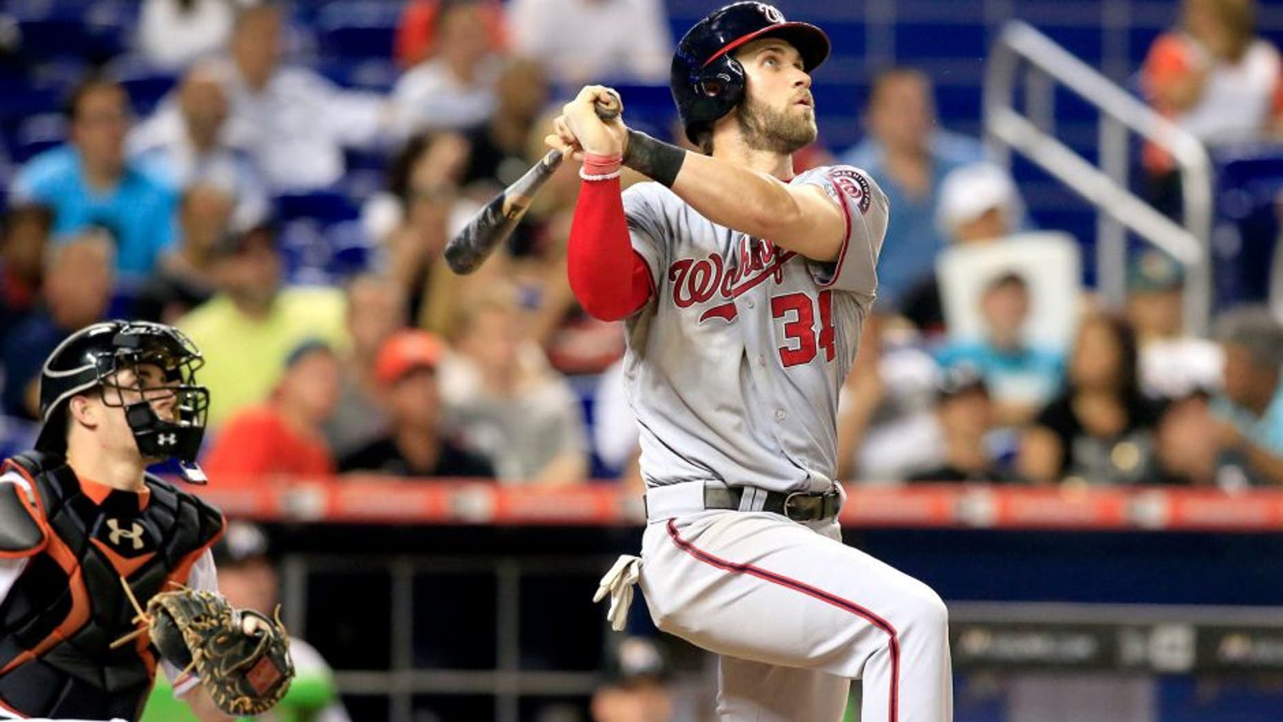 Jul 29, 2015; Miami, FL, USA; Washington Nationals right fielder Bryce Harper (34) hits a home run in the eighth inning against the Miami Marlins at Marlins Park. Mandatory Credit: Robert Mayer-USA TODAY Sports