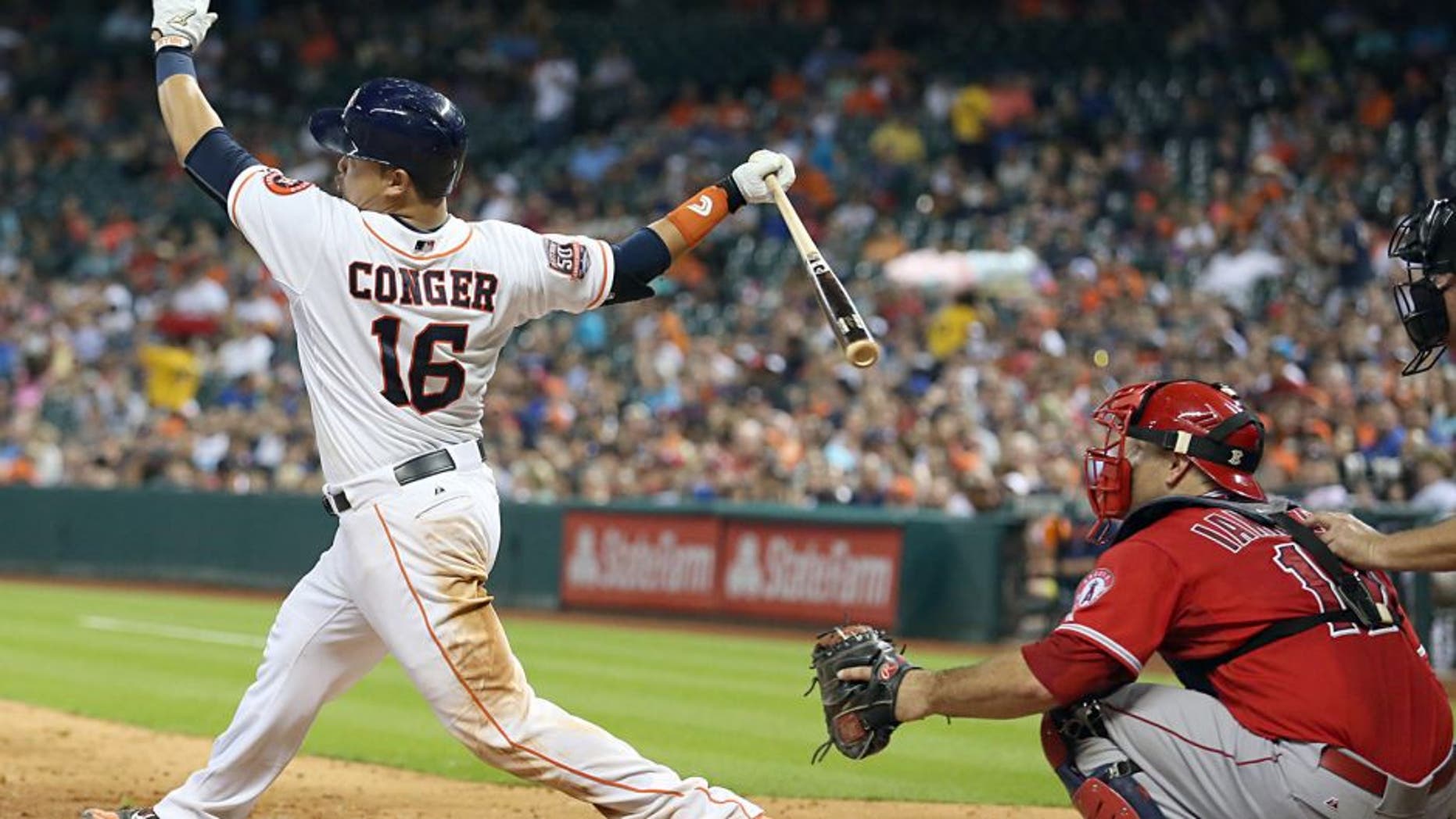 Jul 28, 2015; Houston, TX, USA; Houston Astros catcher Hank Conger (16) hits a double against the Los Angeles Angels in the sixth inning at Minute Maid Park. Astros won 10-5. Mandatory Credit: Thomas B. Shea-USA TODAY Sports