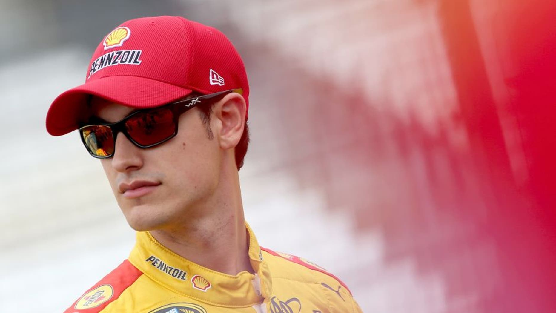 INDIANAPOLIS, IN - JULY 25: Joey Logano, driver of the #22 Shell Pennzoil Ford, stands on the grid during qualifying for the NASCAR Sprint Cup Series Crown Royal Presents the Jeff Kyle 400 at the Brickyard at Indianapolis Motor Speedway on July 25, 2015 in Indianapolis, Indiana. (Photo by Brian Lawdermilk/Getty Images)
