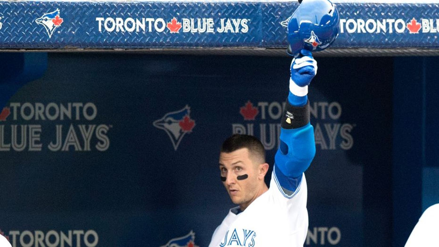 Toronto Blue Jays' Troy Tulowitzki tips his helmet after hitting a two-run home run during the third inning of a baseball game against the Philadelphia Phillies, Wednesday, July 29, 2015, in Toronto. (Darren Calabrese/The Canadian Press via AP) MANDATORY CREDIT