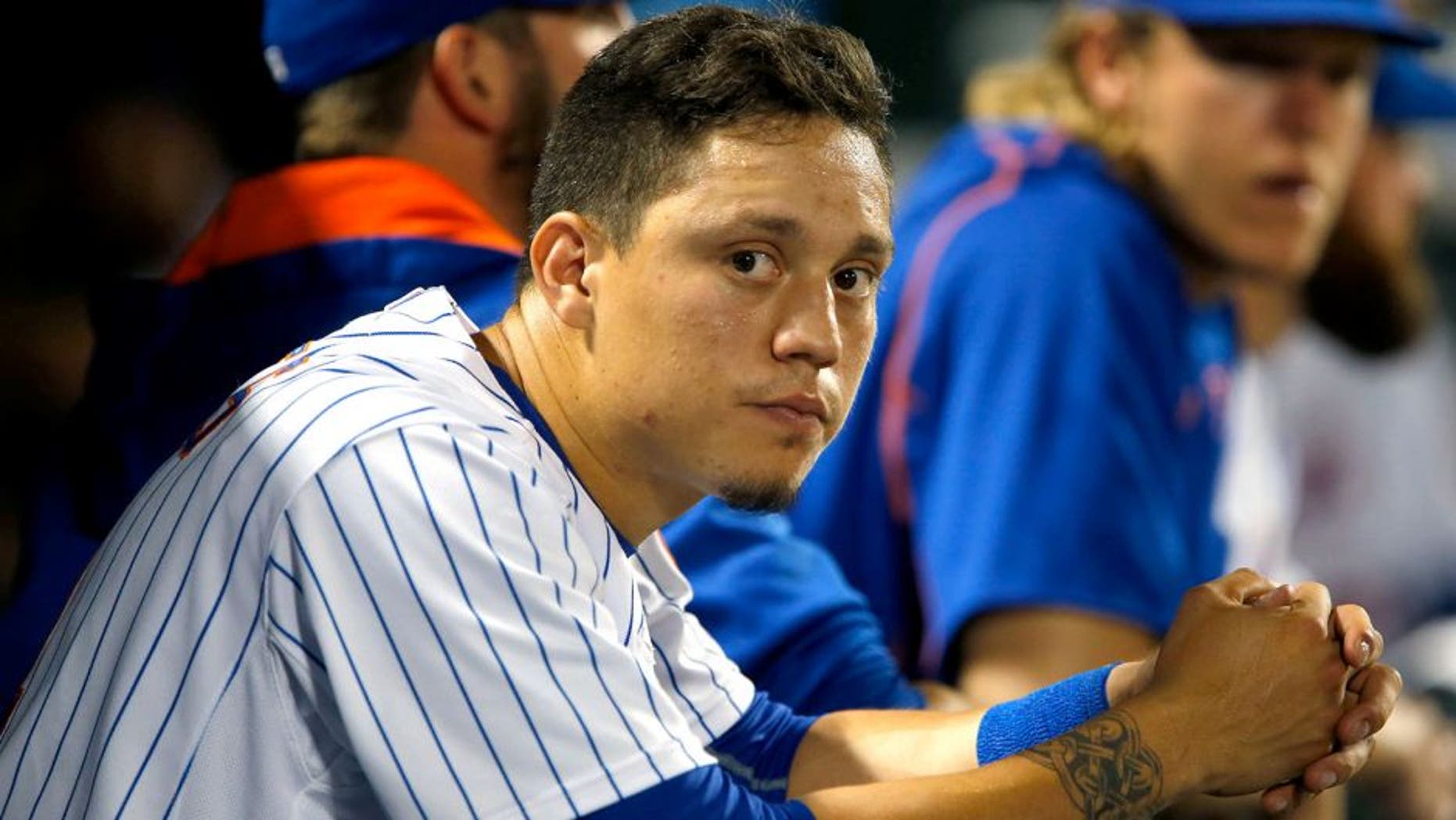 Jul 29, 2015; New York City, NY, USA; New York Mets shortstop Wilmer Flores (4) dejected in the dugout during game against the San Diego Padres at Citi Field. Mandatory Credit: Noah K. Murray-USA TODAY Sports