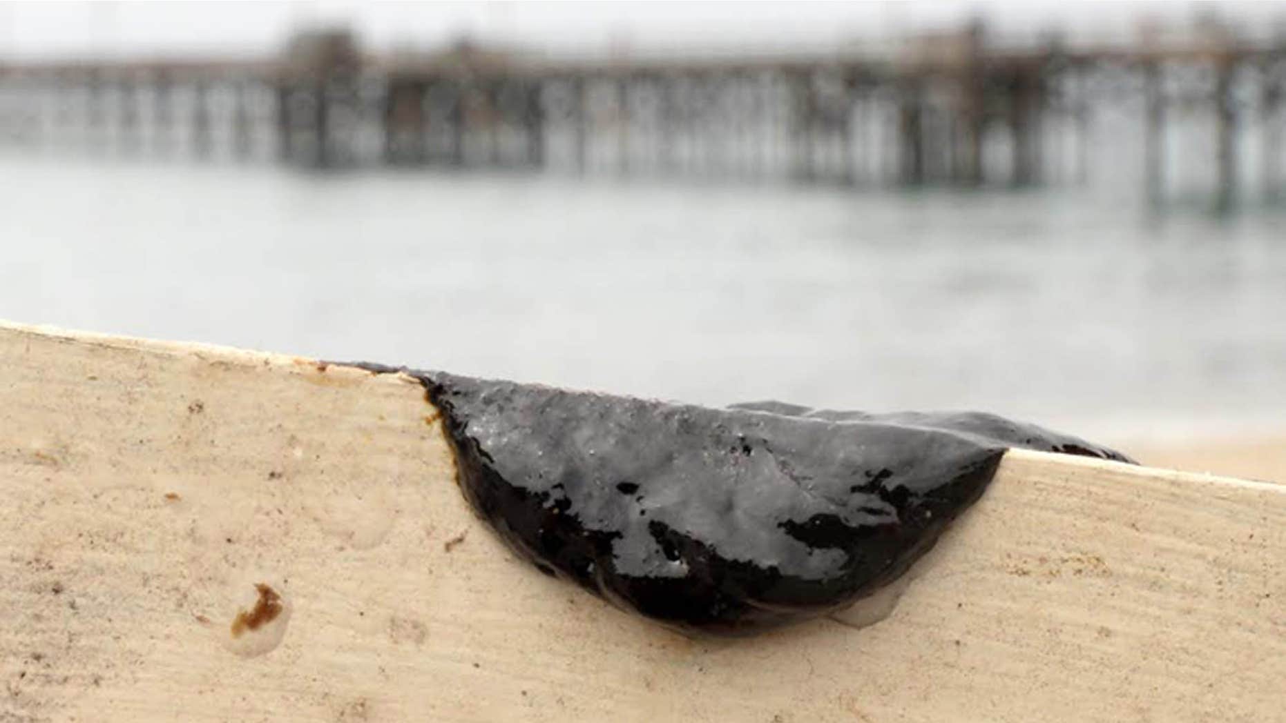 July 29, 2015: This photo provided by the Santa Barbara County, Calif., Fire Department shows a sample of oil scraped off the side of a kayak after two kayakers encountered a large oil sheen and called the fire department to investigate, seen at the Goleta Beach parking lot in Goleta, Calif