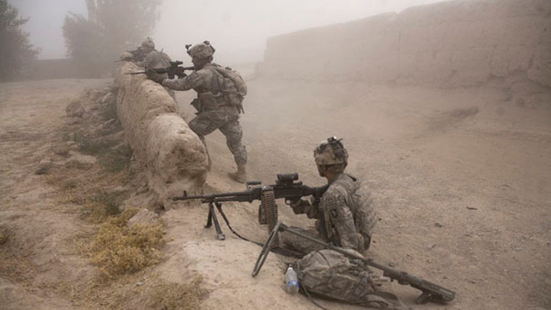 FILE: U.S. soldiers stand guard as a medical helicopter arrives to evacuate a soldier who was seriously wounded when he stepped on an improvised mine in Kandahar province.