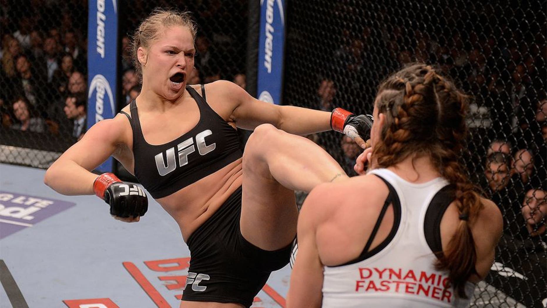 LAS VEGAS, NV - DECEMBER 28: (L-R) Ronda Rousey kicks Miesha Tate in their UFC women's bantamweight championship bout during the UFC 168 event at the MGM Grand Garden Arena on December 28, 2013 in Las Vegas, Nevada. (Photo by Donald Miralle/Zuffa LLC/Zuffa LLC via Getty Images)