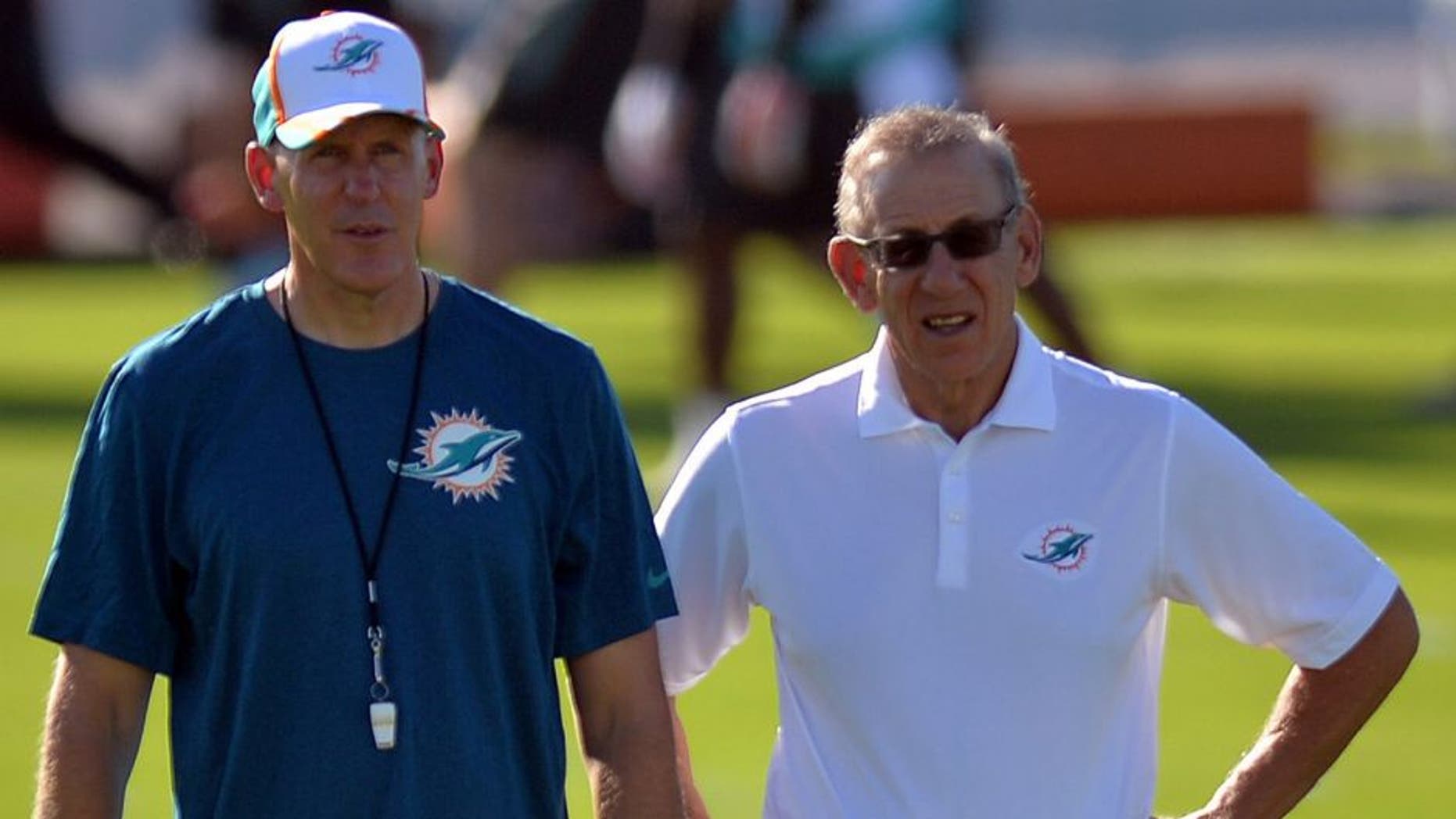 Jul 25, 2014; Davie, FL, USA; Miami Dolphins head coach Joe Philbin (left) talks with the Dolphins owner Stephen Ross (right) at Miami Dolphins Training Facility. Mandatory Credit: Steve Mitchell-USA TODAY Sports