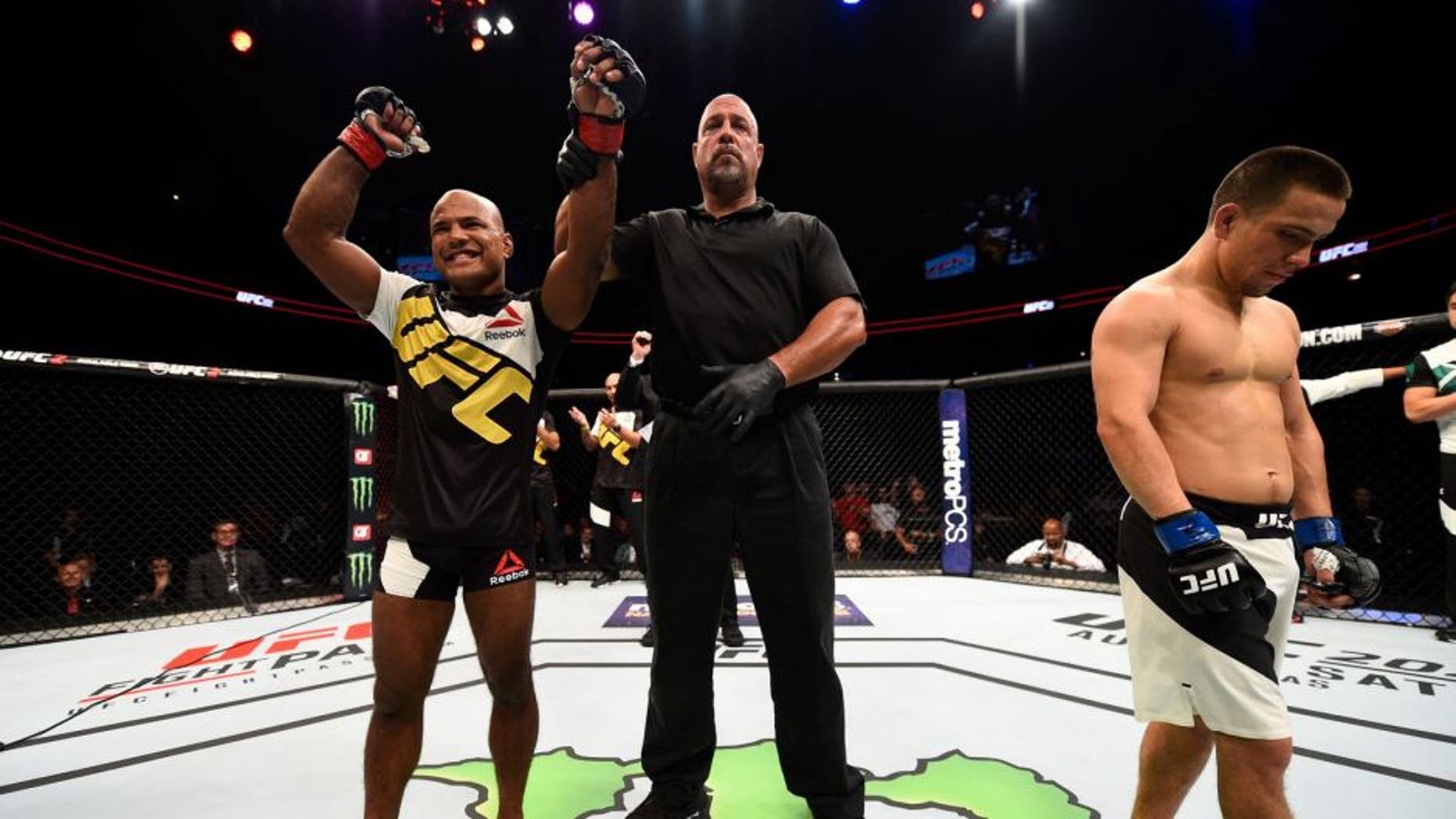 ATLANTA, GA - JULY 30: (L-R) Wilson Reis celebrates his submission victory over Hector Sandoval in their flyweight bout during the UFC 201 event on July 30, 2016 at Philips Arena in Atlanta, Georgia. (Photo by Jeff Bottari/Zuffa LLC/Zuffa LLC via Getty Images)
