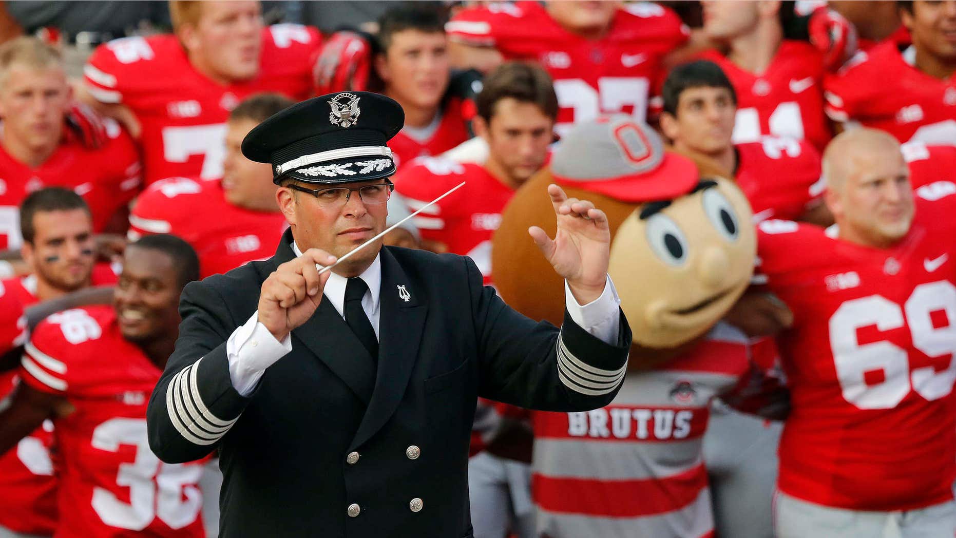 Sept. 7, 2013: Ohio State University marching band director Jonathan Waters leads the band in "Carmen Ohio" following an NCAA football game against San Diego State at Ohio Stadium in Columbus, Ohio.