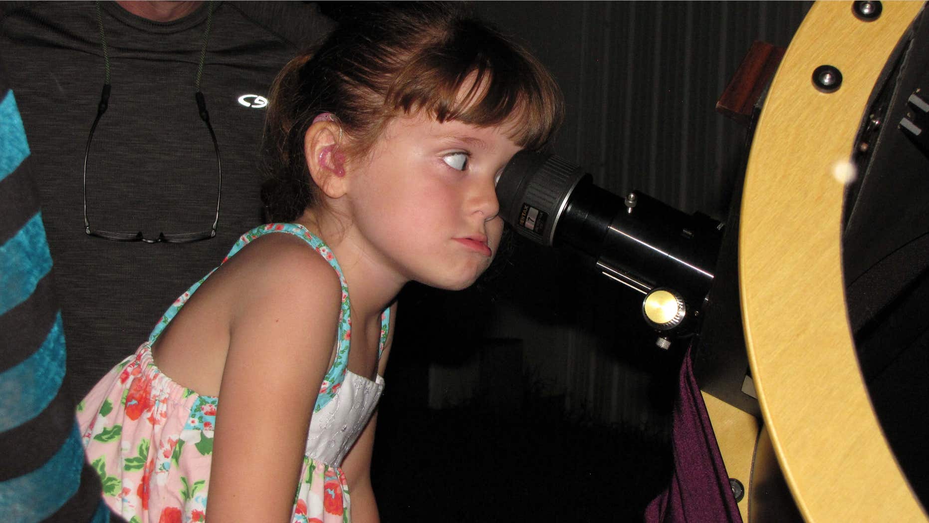 July 28, 2015: Elizabeth “Lizzy” Myers, 5, gazes through a telescope at the Warren Rupp Observatory in Bellville, Ohio.