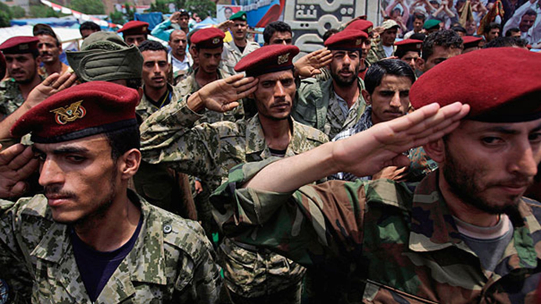 July 31: Defected soldiers salute during a protest demanding the resignation of Yemen's President Ali Abdullah Saleh in Sanaa, Yemen.