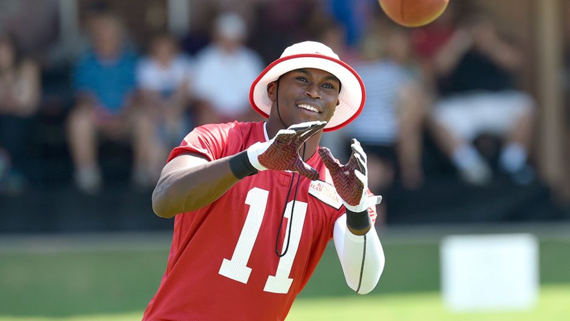 Jul 26, 2014; Atlanta, GA, USA; Atlanta Falcons wide receiver Julio Jones (11) reacts while catching passes on the field during training camp at Falcons Training Complex. Mandatory Credit: Dale Zanine-USA TODAY Sports